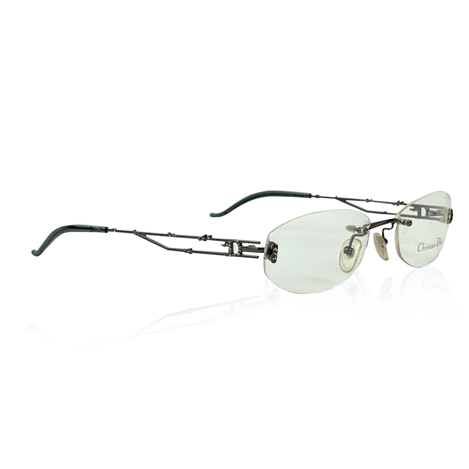 Vintage Eyeglasses by Christian Dior Mod. 3616, from the 90s. Made in Austria.Rimless design with gunmetal cut-out ear stems embellished with small crystals. Clear / trasparent DEMO lens, with Christian Dior signature. Model refs: Mod. CD 3616 - 70