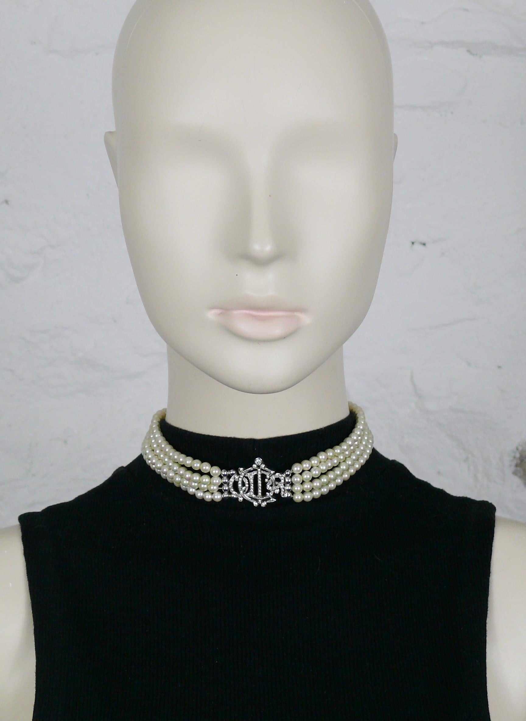 CHRISTIAN DIOR vintage choker necklace featuring four strands of off-white faux pearls and a silver toned C  D I O R logo embellished with clear crystals.

Silver tone metal hardware.

Secure clasp closure.
Extension chain.

Embossed CHR DIOR