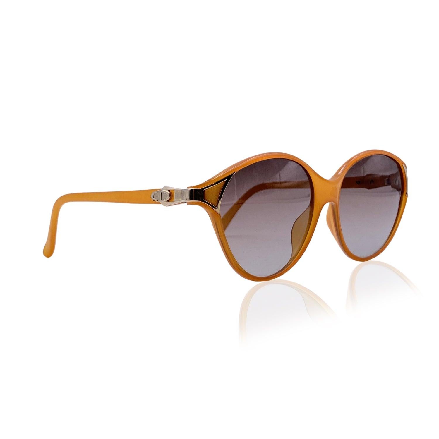 Vintage Christian Dior sunglasses, 2306 40. Orange Optyl frame. Gold metal accents. Cat-eye shape. Original 100% Total UVA/UVB protection gradient lenses in grey color. CD logo on temples. Made in Germany Details MATERIAL: Acetate COLOR: Orange