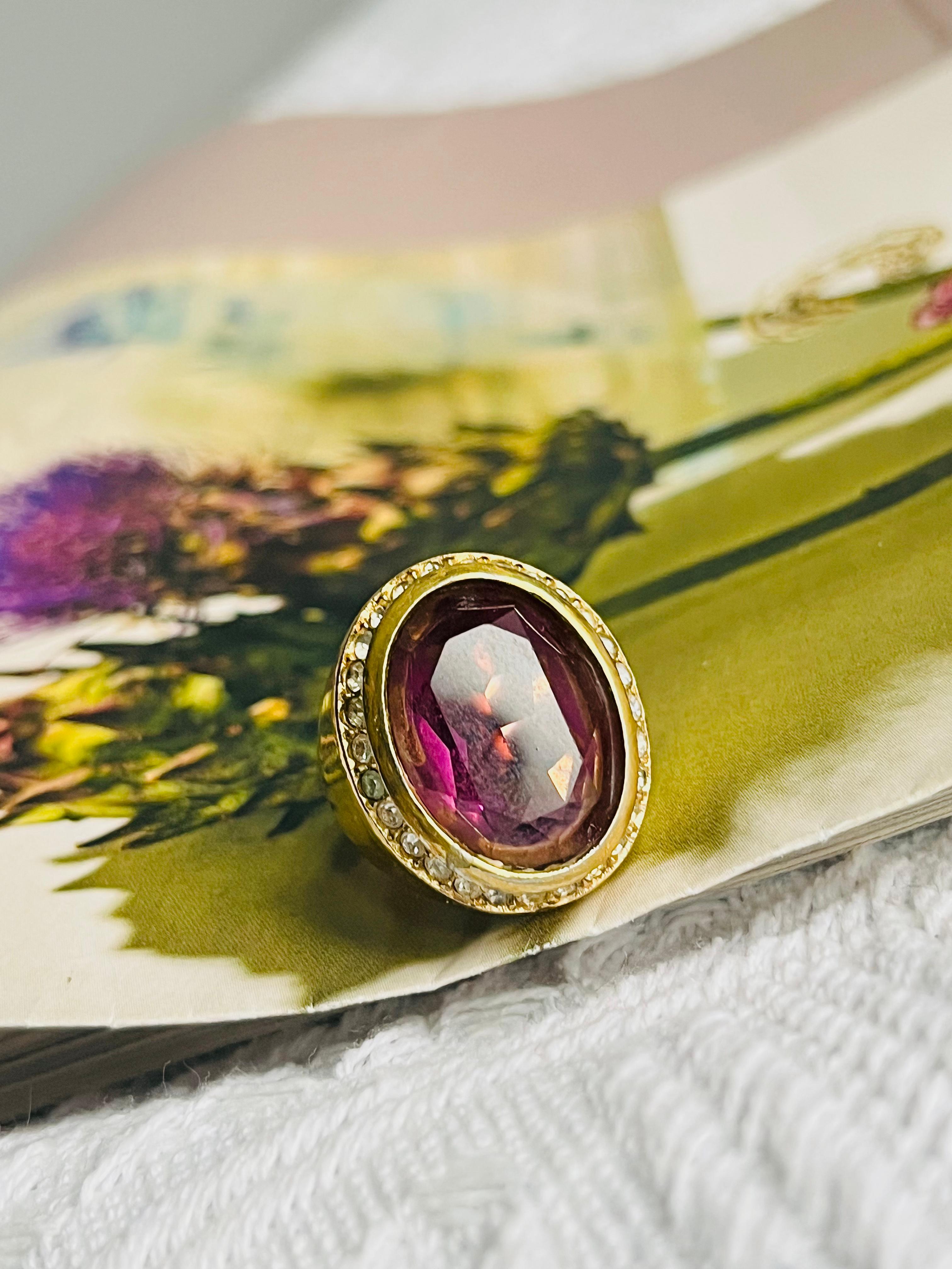 Christian Dior Vintage 1980s Unisex Oval Amethyst Purple Crystals Halo Cocktail Statement Chunky Ring, US 7, Gold Tone

Good condition. Some scratches and colour loss. So the price is low. 100% Genuine.

Very beautiful ring. Very rare to find.