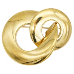 Spilla vintage Christian Dior, rara, in oro, a forma di grande cerchio luminoso, con motivo a spirale e intrecci