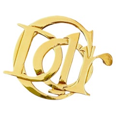 Spilla vintage Christian Dior, rara, in oro, con grandi lettere del logo Monogram intrecciate