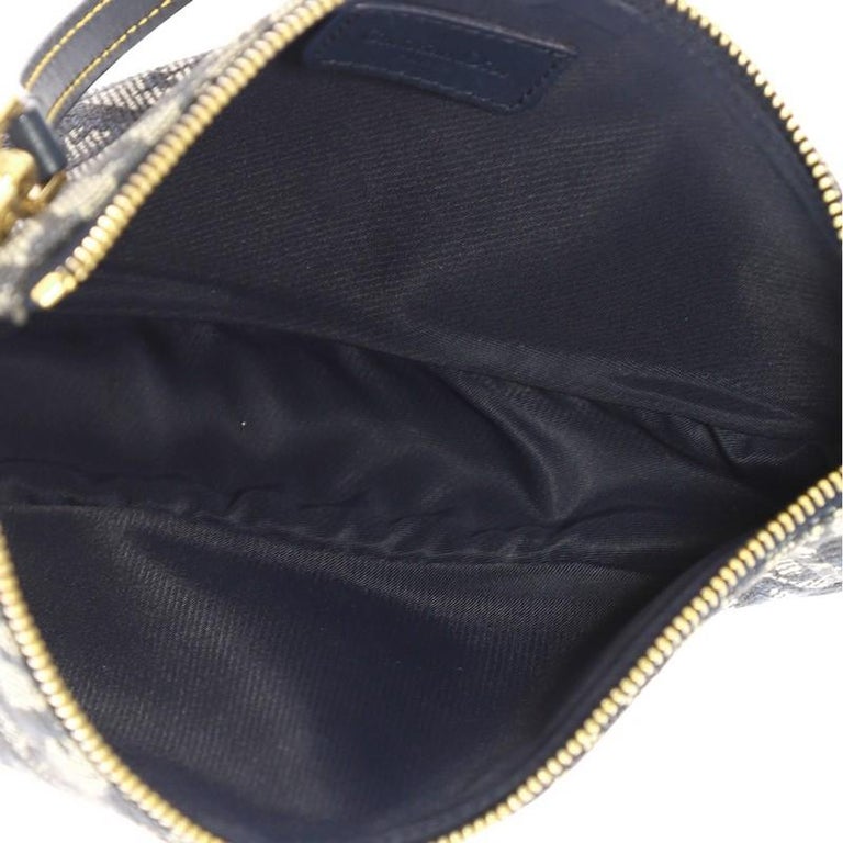 Sold at Auction: Christian Dior - a saddle pochette in blue Diorissimo  canvas, circa 2001, blue leather trims and pipings with contrasting yellow  stitching, zip closure and fabric-lined interior, gold-tone hardware. Date