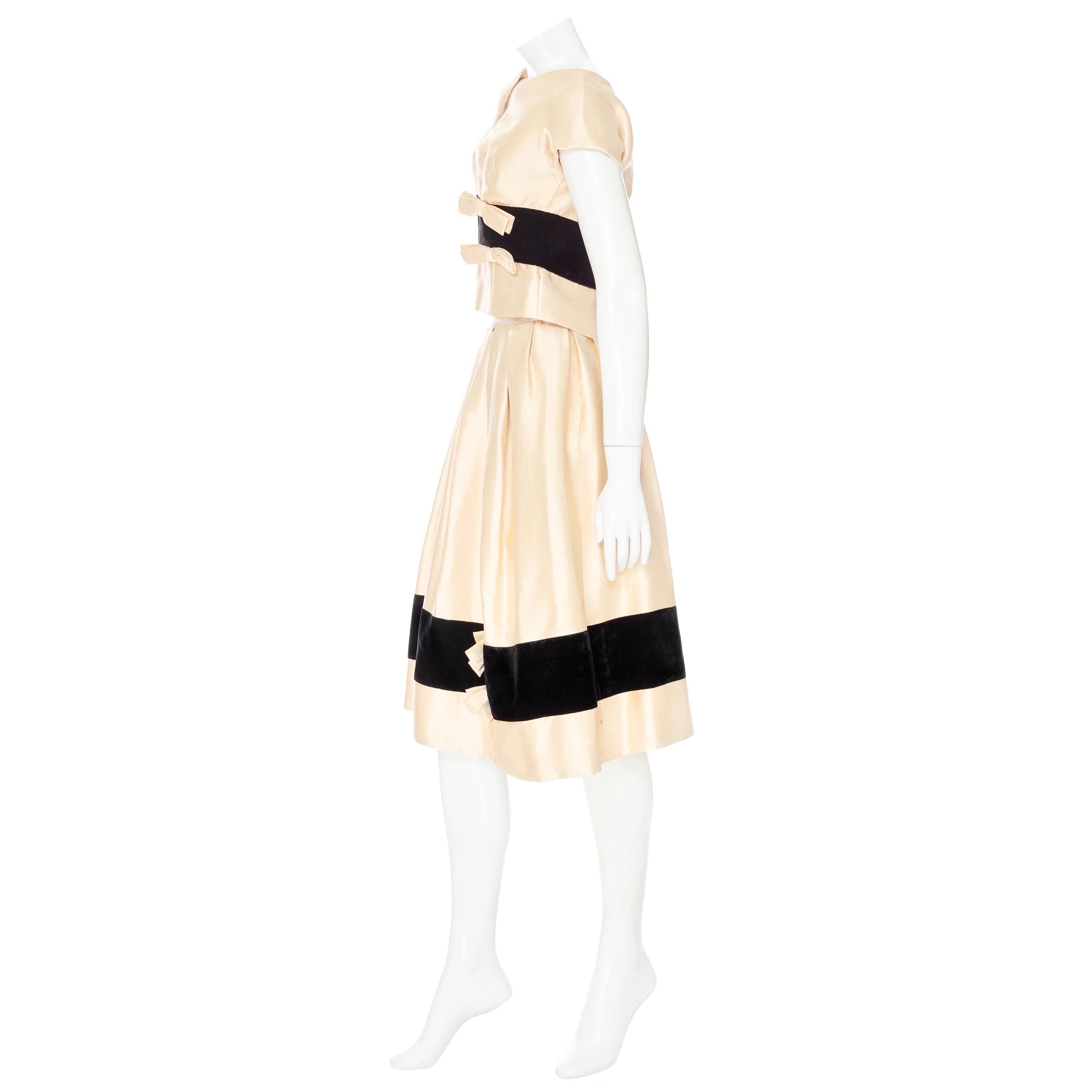 Christian Dior Vintage Cream and Black Satin and Velvet Bow Adorned Dress 

Vintage; circa 1950s
Christian Dior-New York Inc., sold by Saks Fifth Avenue
Cream/Black
Two-piece dress set; spaghetti strap dress with separate top
Velvet stripe at waist