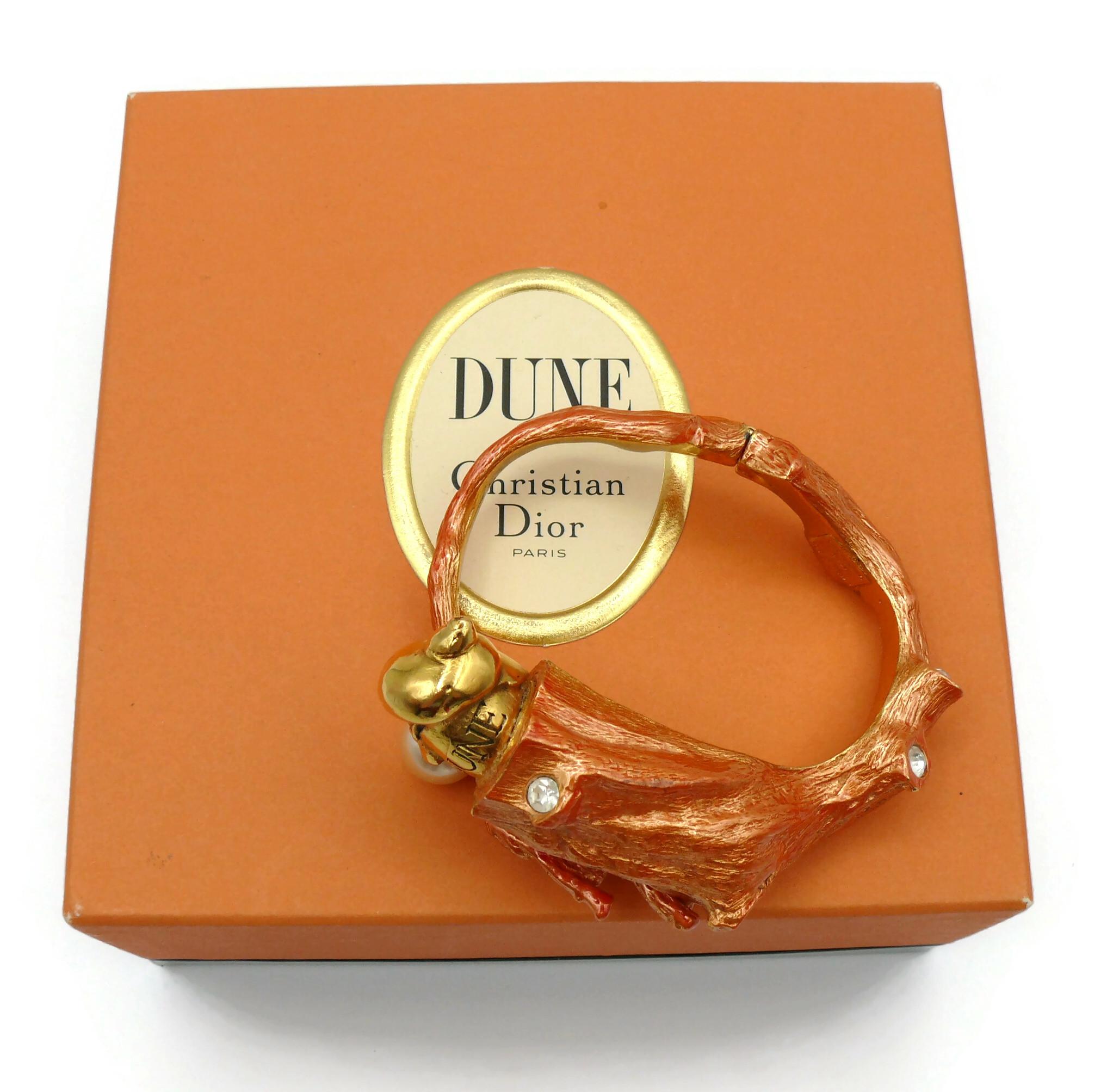 CHRISTIAN DIOR vintage shell clamper bracelet created by the French parurier ROBERT GOOSSENS for the launch of the fragrance DUNE in 1987.

This gold toned with patina bracelet mimics a coral branch. It is embellished with a gold toned shell design