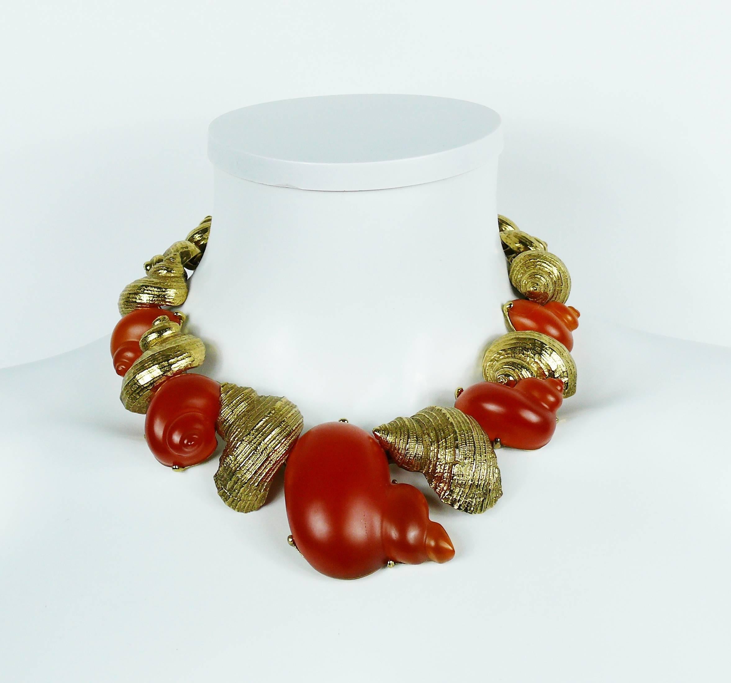 CHRISTIAN DIOR vintage rare shell necklace created by the French parurier ROBERT GOOSSENS for the launch of the fragrance DUNE in 1987.

This necklace features articulated and graduated textured gold toned and orange resin shells.

Embossed