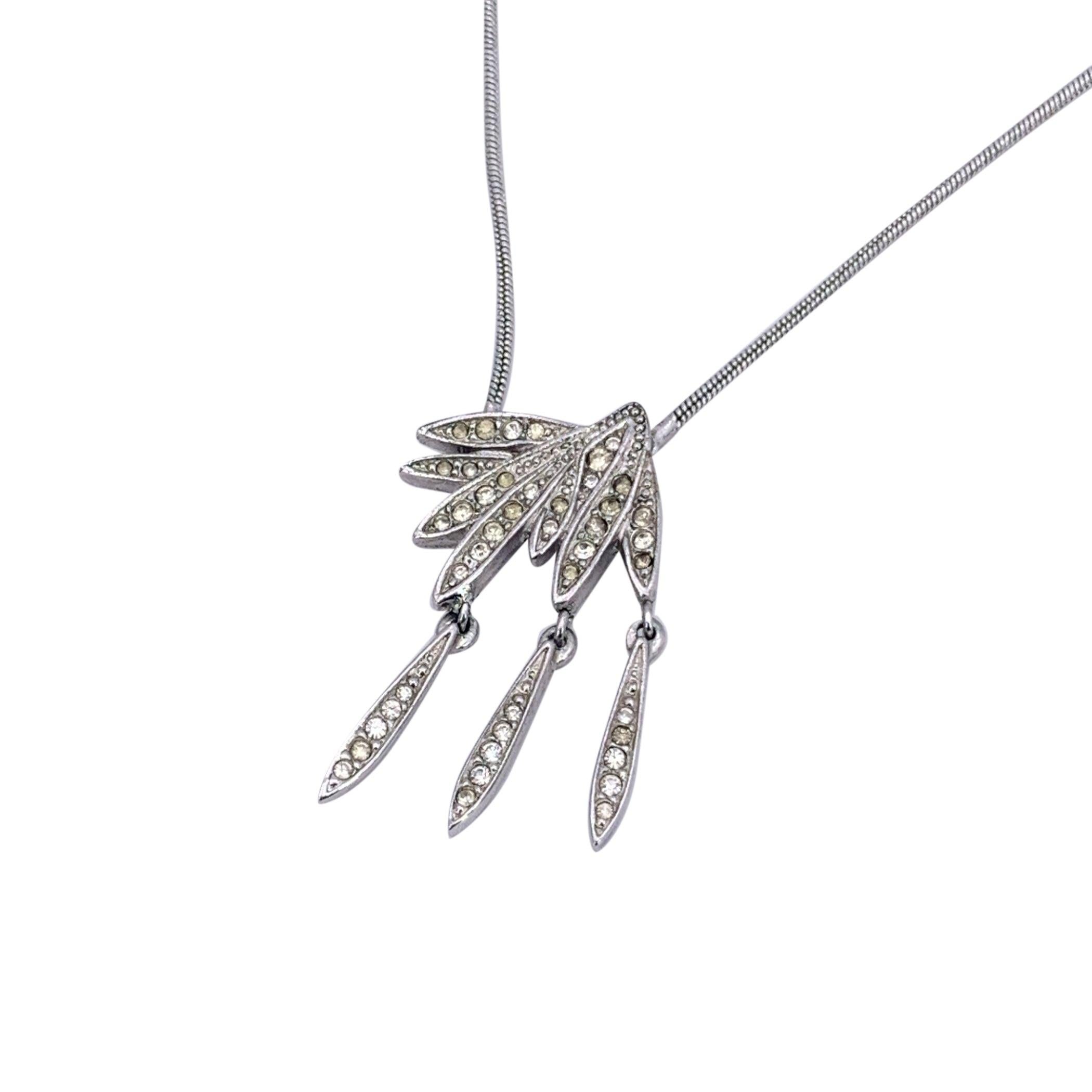 Step back into the glamour of the 1990s with this true vintage Christian Dior necklace, a dazzling piece that perfectly captures the era's refined yet bold aesthetic. Crafted in silver-tone metal and embellished with sparkling crystals, it reflects