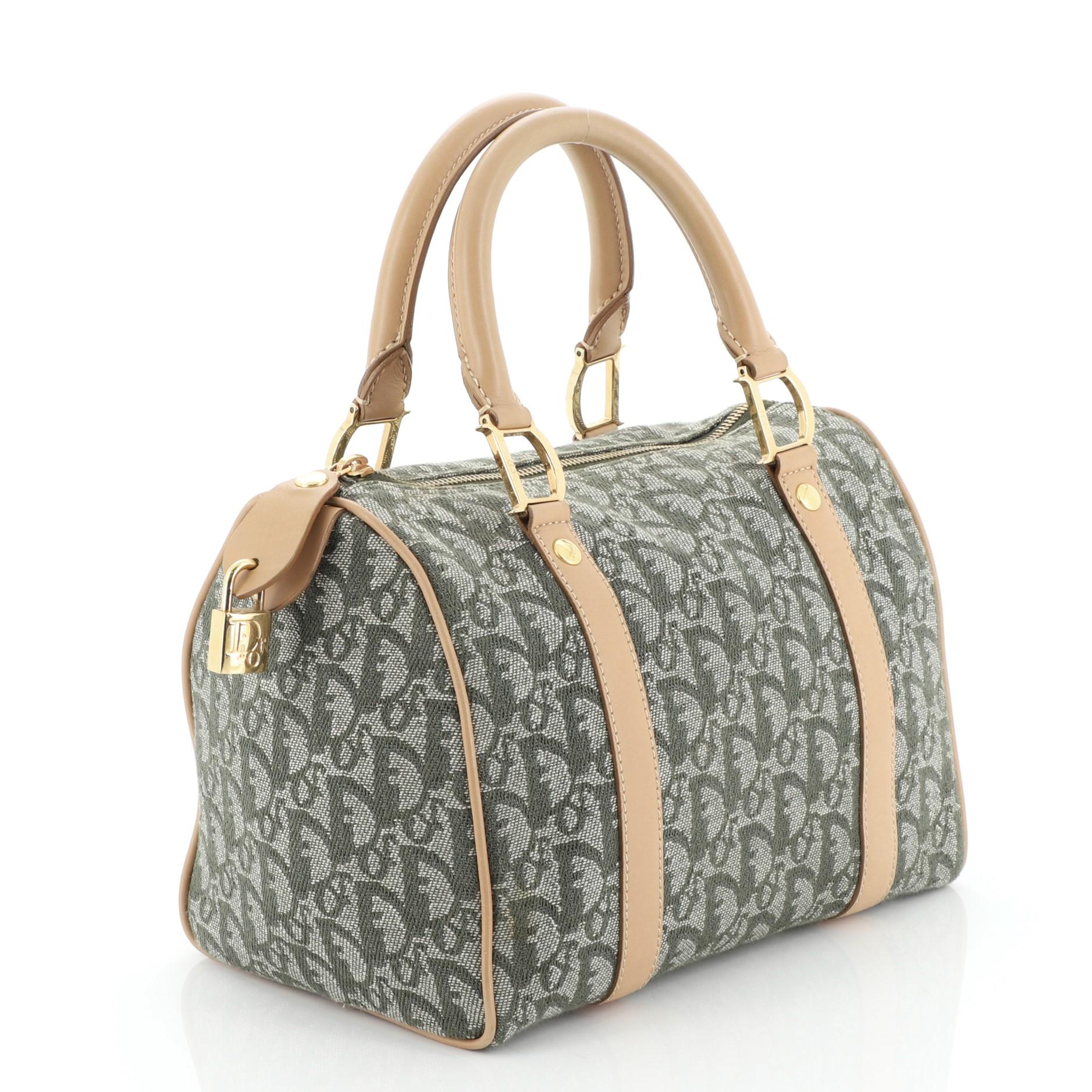 This Christian Dior Vintage Trotter Boston Bag Diorissimo Canvas Small, crafted from green diorissimo canvas, features dual rolled handles, leather trim, and gold-tone hardware. Its zip closure opens to a green nylon interior. 

Condition: Very