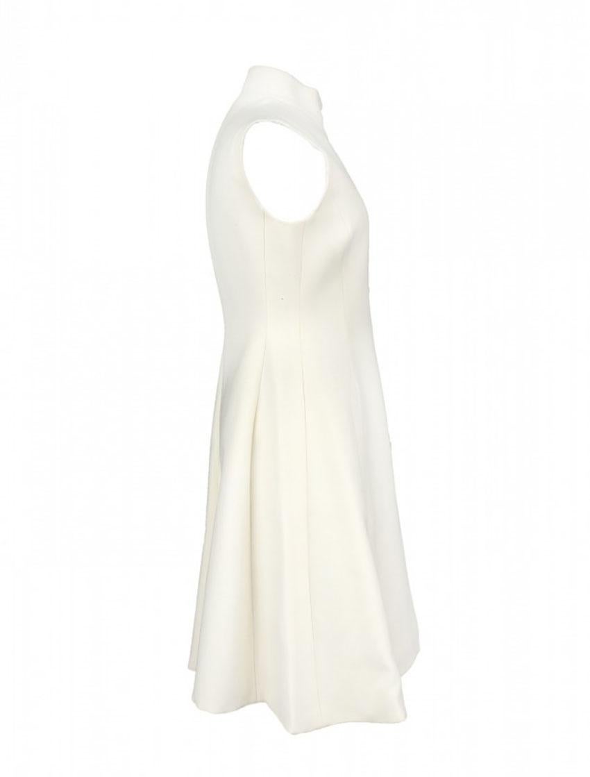 CHRISTIAN DIOR 

Christian Dior dress is made of white wool. Side pockets. 
Fitted silhouette, stand collar. 
Button fastening at the front. 
Tonal silk lining.
2010s, France.

Content: wool, silk

Bust 31 1/2