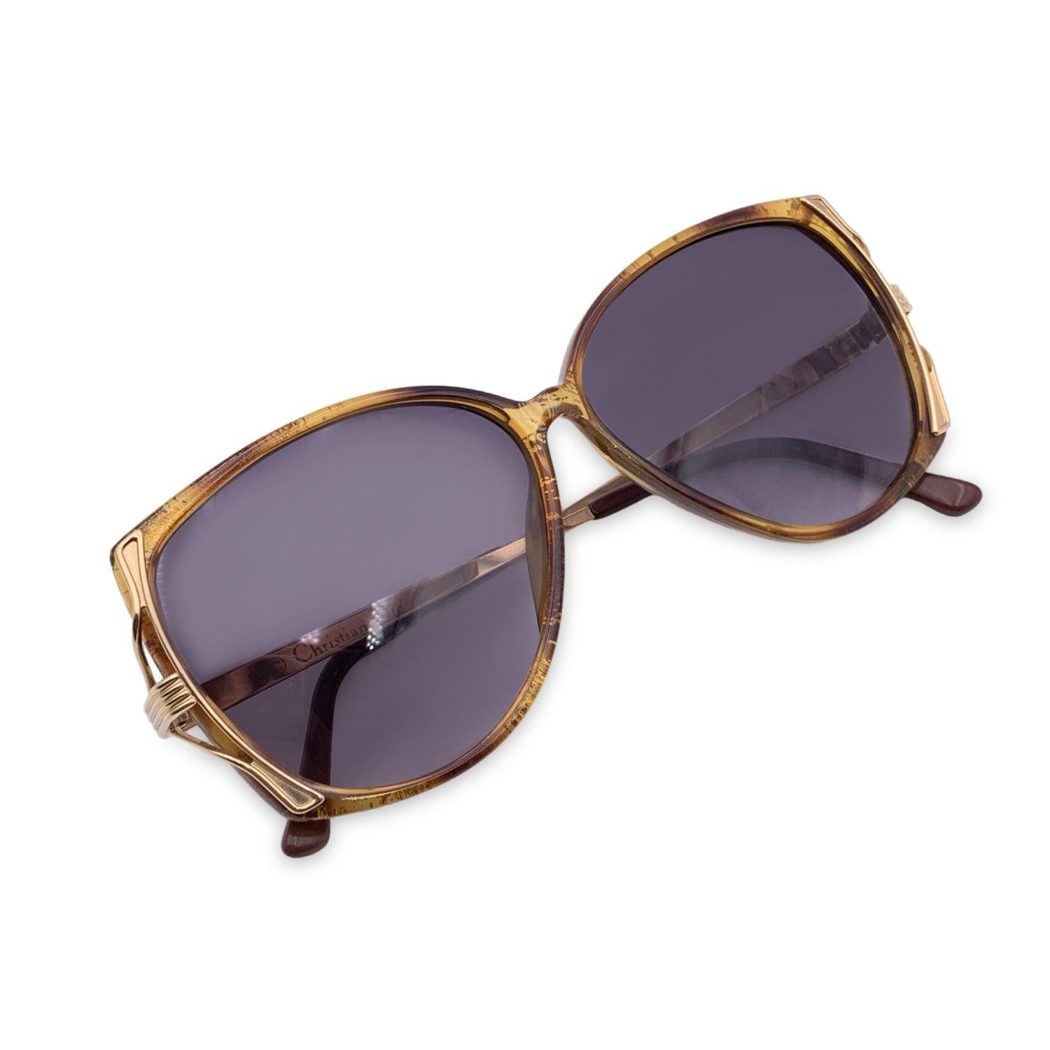 Vintage Christian Dior Unisex Sunglasses, Mod. 2529 11 Size 55/10 130mm. Brown, semi-transparent acetate frame and gold metal arms. 100% Total UVA/UVB protection blue gradient lenses. CD logos on the side of the temples. Details MATERIAL: Plastic