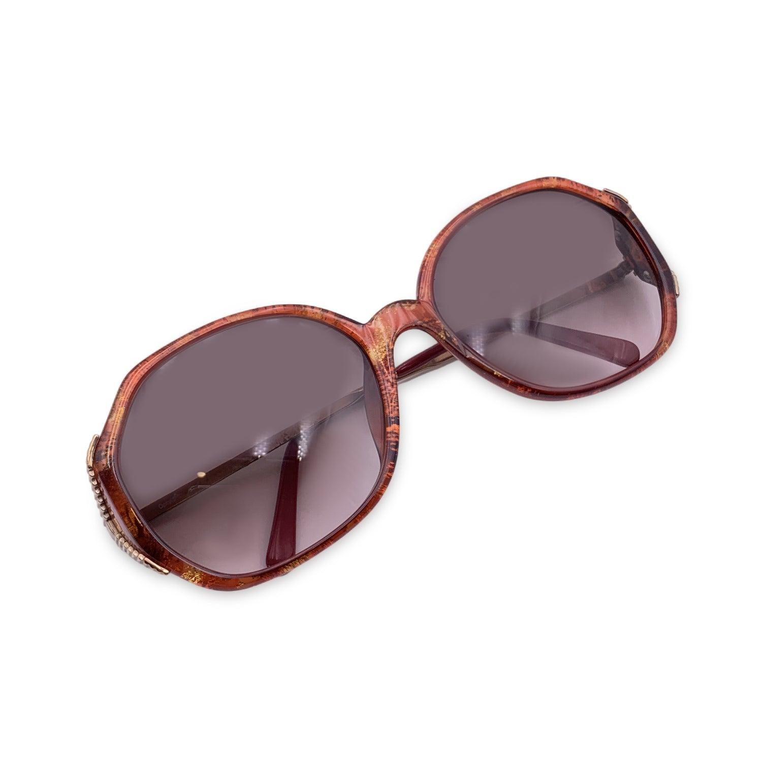 Vintage Christian Dior Women Sunglasses, Mod. 2527 30 Optyl. Size: 58/18 130mm. Burgundy acetate frame with gold metal finish. CD logo on temples . 100% Total UVA/UVB protection. Brown gradient lenses. Details MATERIAL: Plastic COLOR: Burgundy