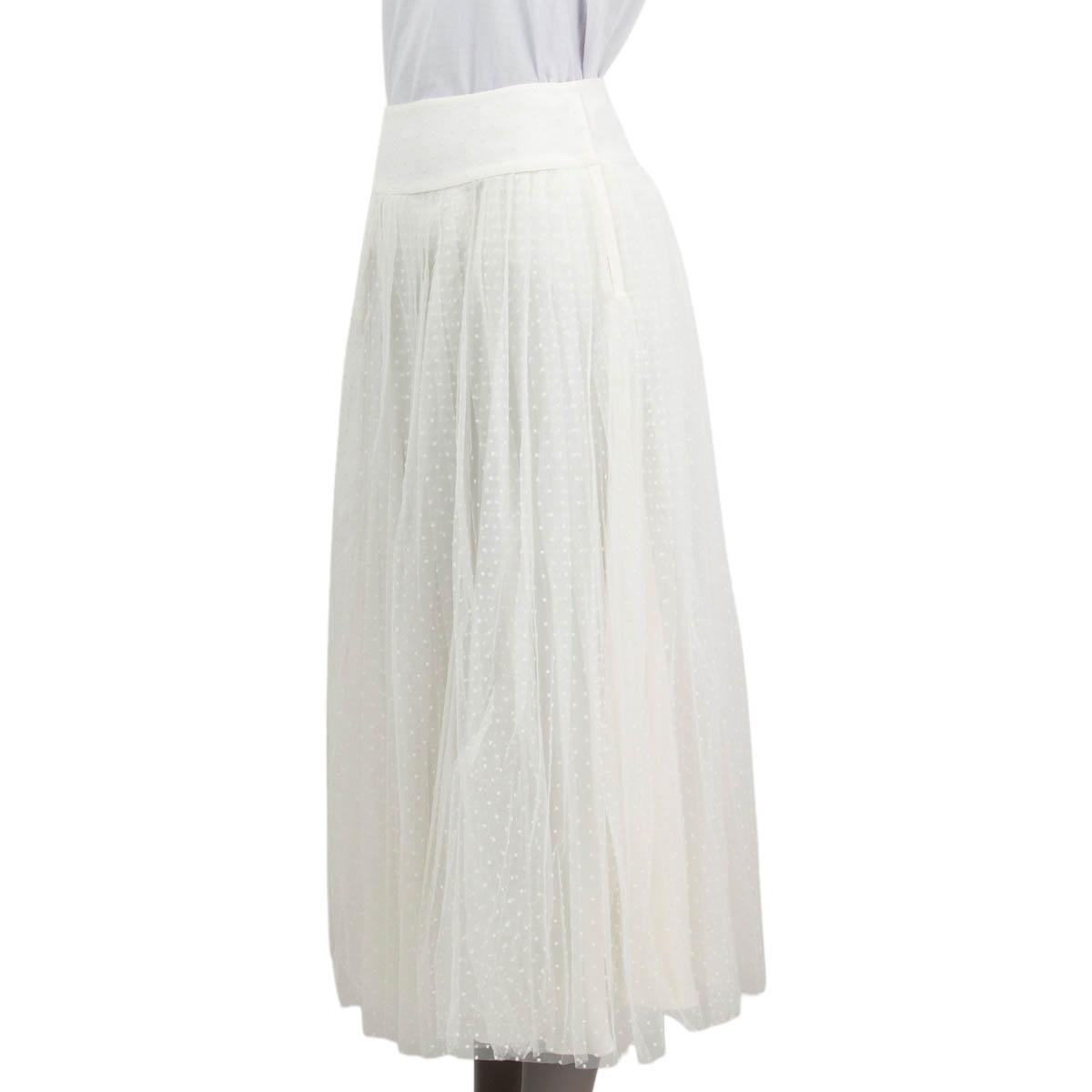 100% authentic Christian Dior Spring/Summer 2017 pleated polka dot tulle midi skirt in off-white polyamide (100%). Opens with push buttons and a hook on the side. Lined in off-white silk (100%). Has been worn and is in excellent