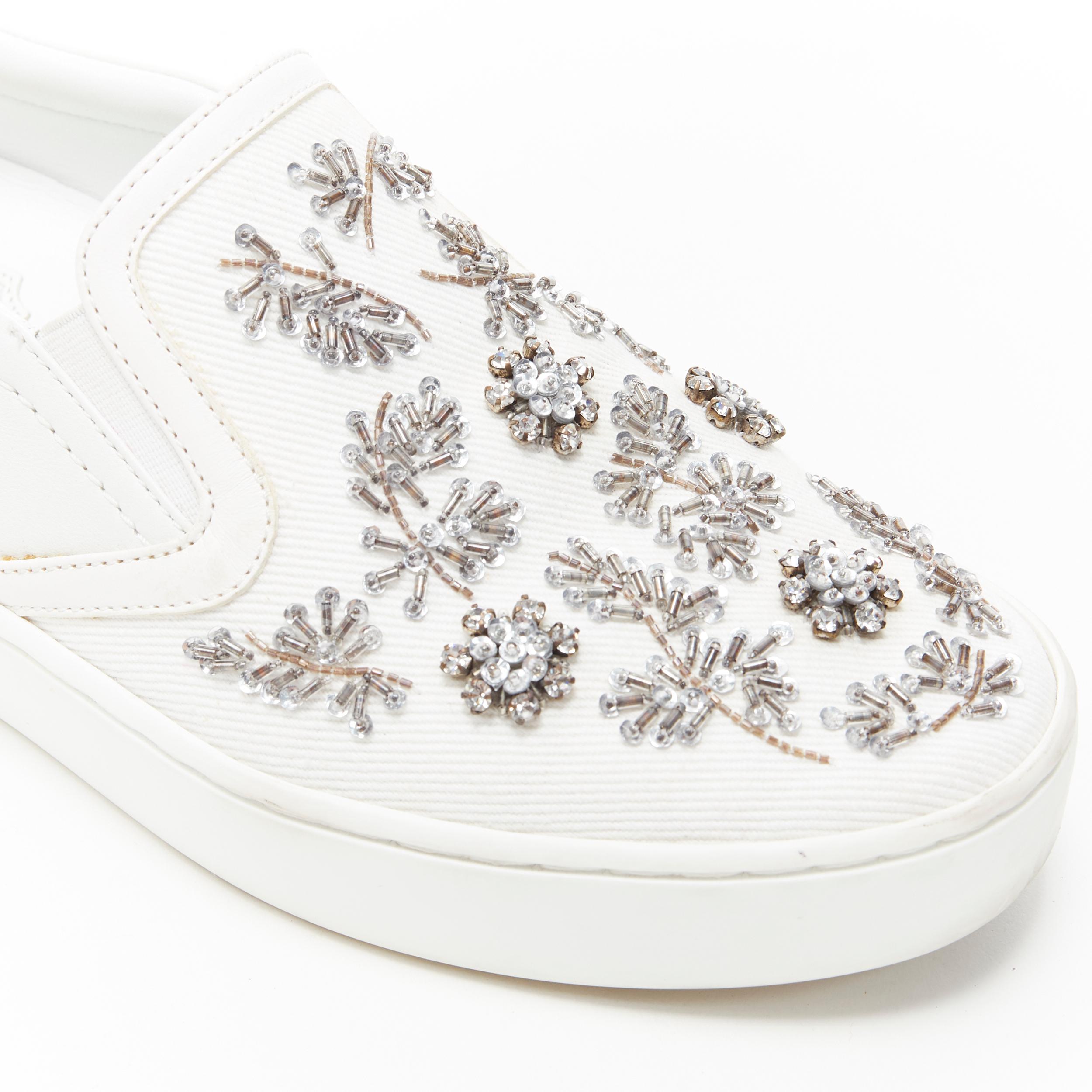 CHRISTIAN DIOR white bead crystal embellished low top skate sneakers EU37 Reference: LNKO/A01675 
Brand: Christian Dior 
Material: Fabric 
Color: White 
Pattern: Solid 
Extra Detail: White canvas upper. Bead and crystal embellishment on upper.