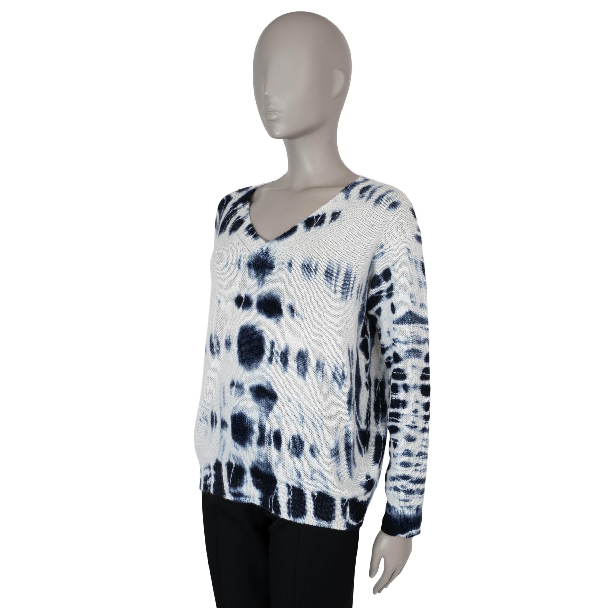 This 100% authentic Christian Dior sweater in cream and midnight blue tie-dye cashmere (100%) embodies effortless luxury with a contemporary edge. Designed with an oversized silhouette, it features dropped shoulders, a flattering V-neck, and