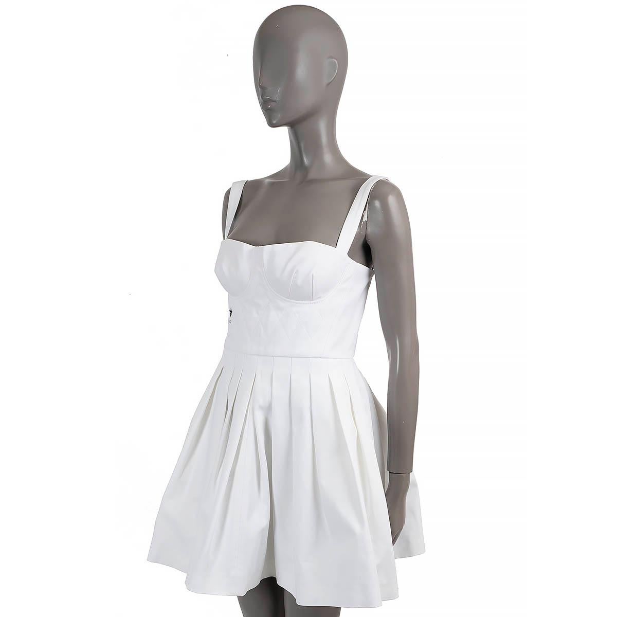 100% authentic Christian Dior sleeveless bustier mini dress in white cotton (100%). Features a quilted bustier top with CD Bee embroidery in black and a pleated skirt. Opens with a concealed zipper in the back and is unlined. Has been worn and is in