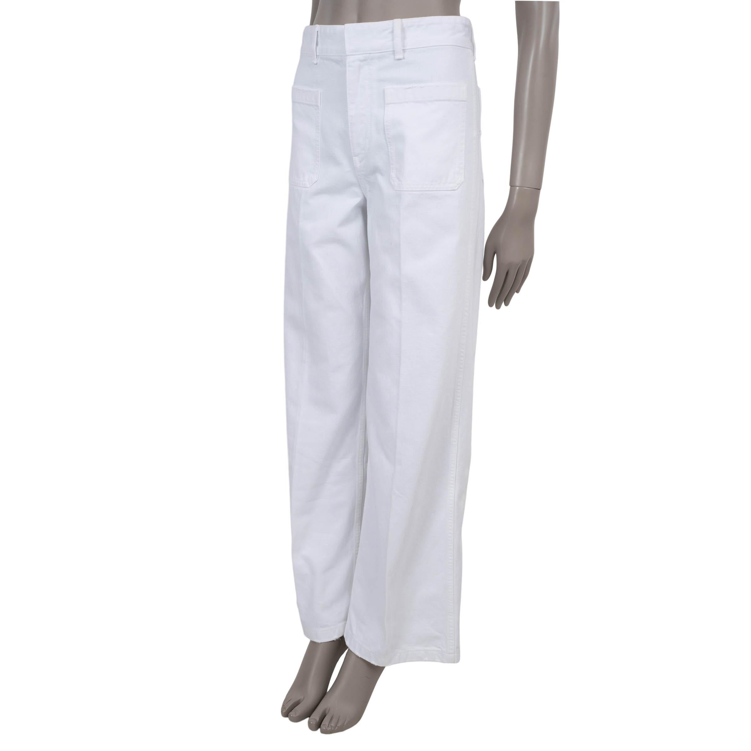 This 100% authentic Christian Dior 8 jean is crafted in white cotton denim and designed with a relaxed, flared silhouette. The style features two front and two back patch pockets, and is finished with the signature Dior jacron label on the back,