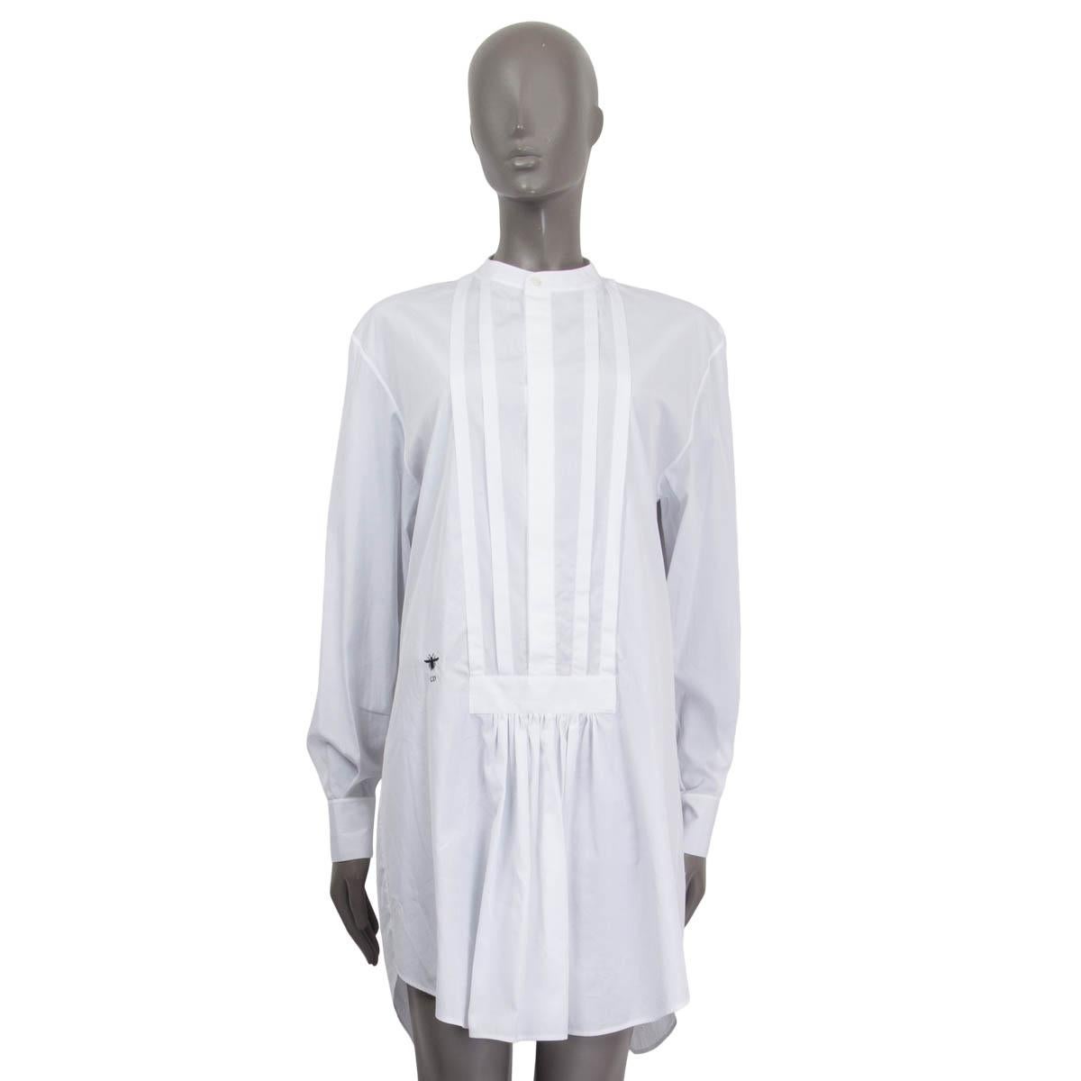 100% authentic Christian Dior pleated shirt dress in white cotton (100%). Features long buttoned sleeves and a round neck. Has an embroidered 'CD' logo on the front. Opens with seven concealed buttons on the front. Unlined. Has been worn and is in