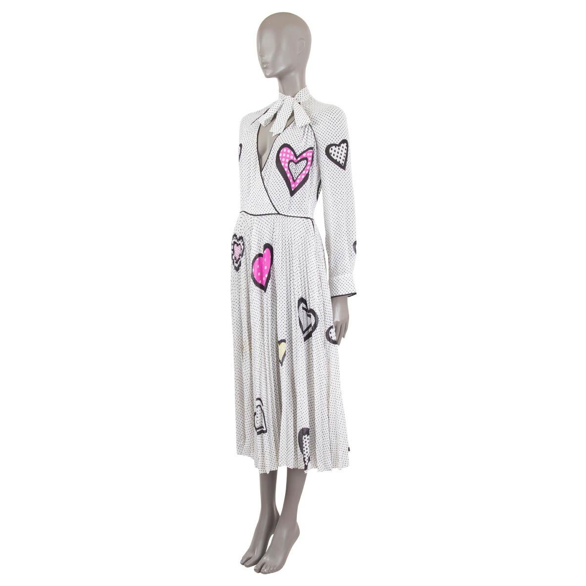 100% authentic Christian Dior long sleeve pleated heart & polka dot printed sheer midi dress in white and black silk (100%) with details in yellow and pink. The design features a deep v-neck and pussy bow around the neck. Opens with a zipper on the
