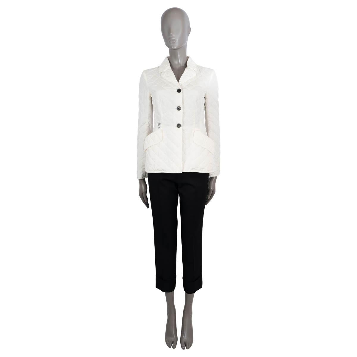 100% authentic Christian Dior quilted blazer in white silk (100%). Features a notch collar, two flap pockets on the front and bee embroidered logo. Opens with three buttons on the front. Unlined with polyester (100%) padding. Has been worn and is in