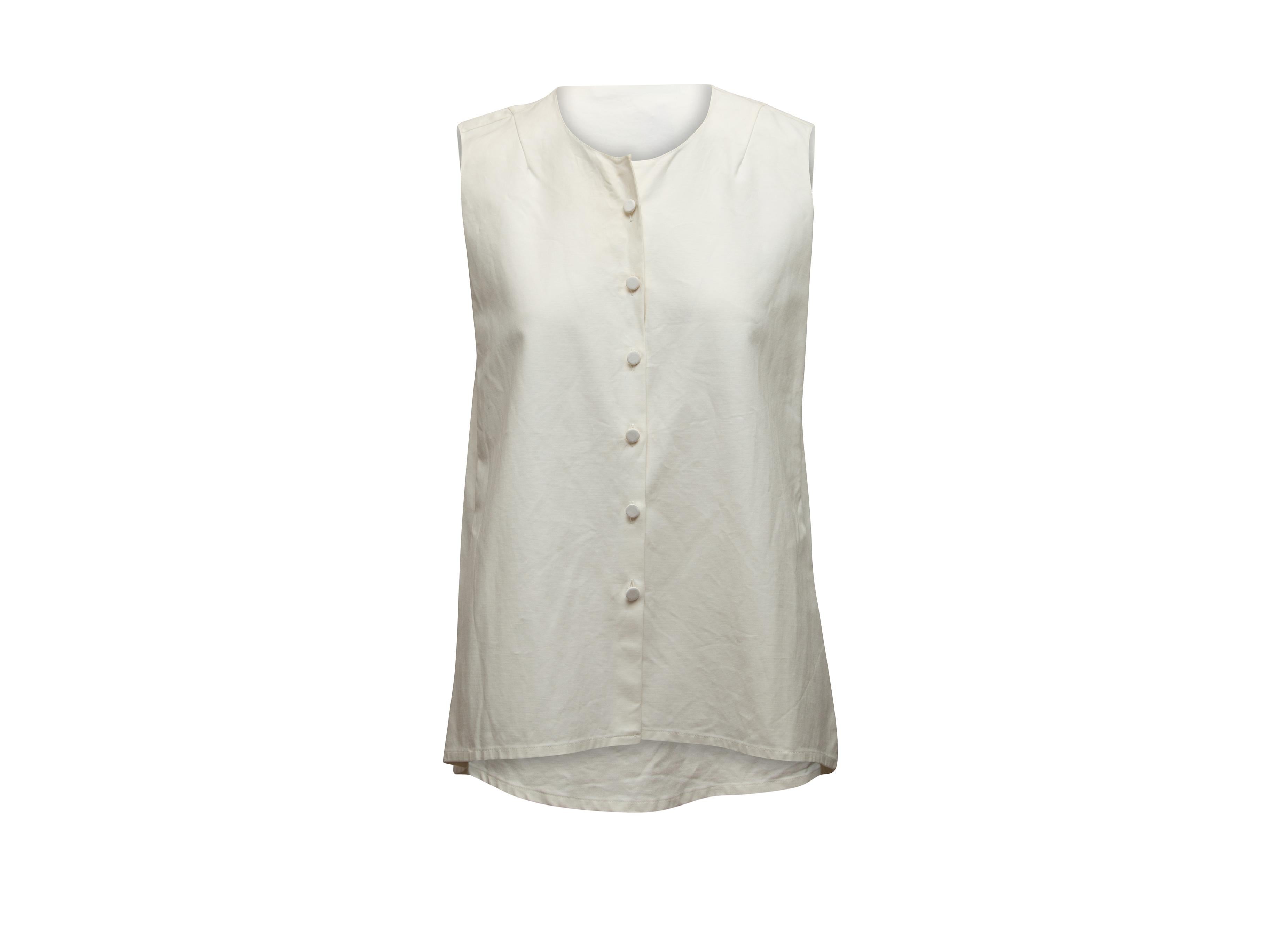 Product details: White sleeveless button-up top by Christian Dior. Crew neck. Button closures at center front. 28