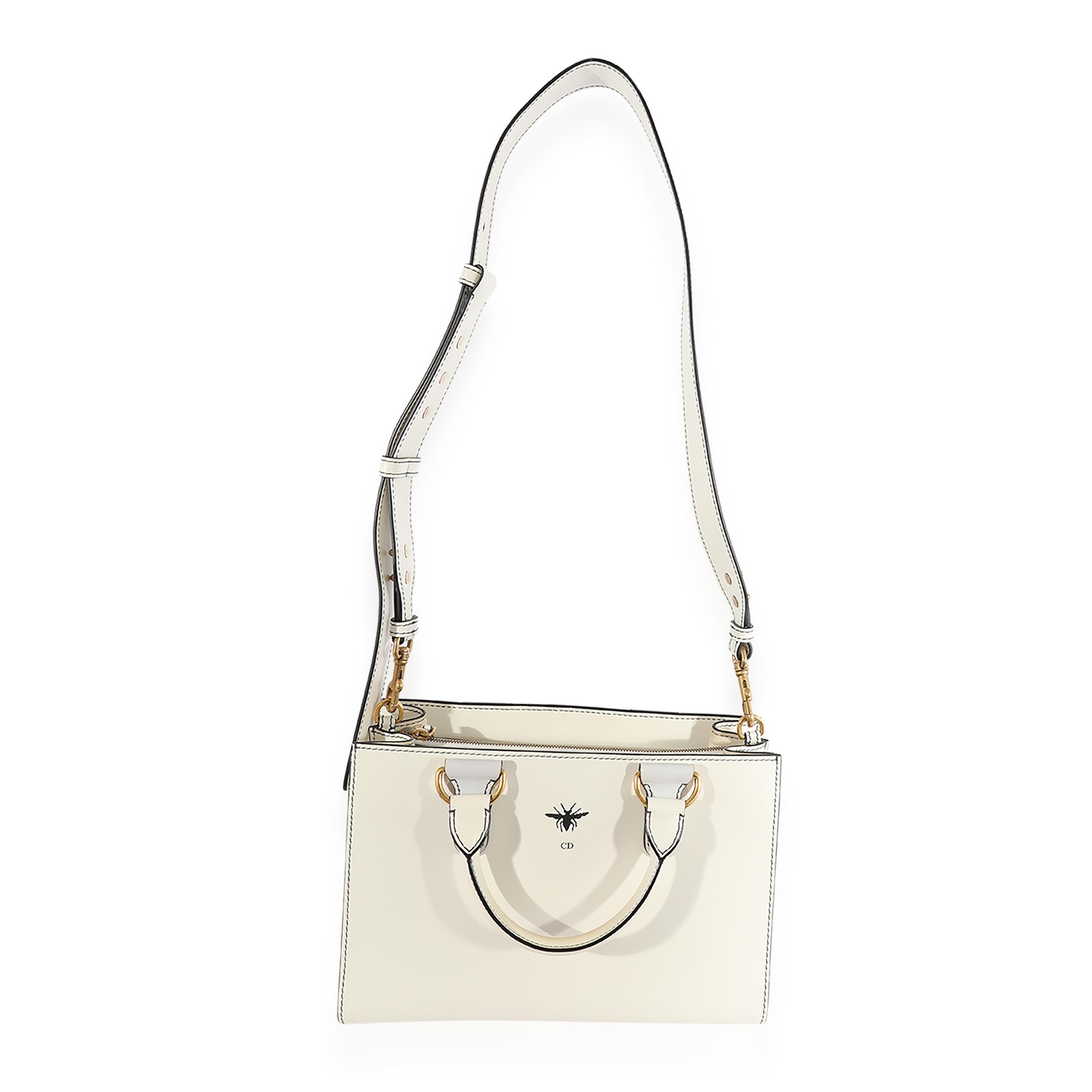 Listing Title: Christian Dior White Smooth Leather D-Bee Tote
SKU: 123397
MSRP: 3720.00 USD
Condition: Pre-owned 
Condition Description: The Dior Book tote combines practicality with impeccable style. Embroidered throughout for a look reminiscent of