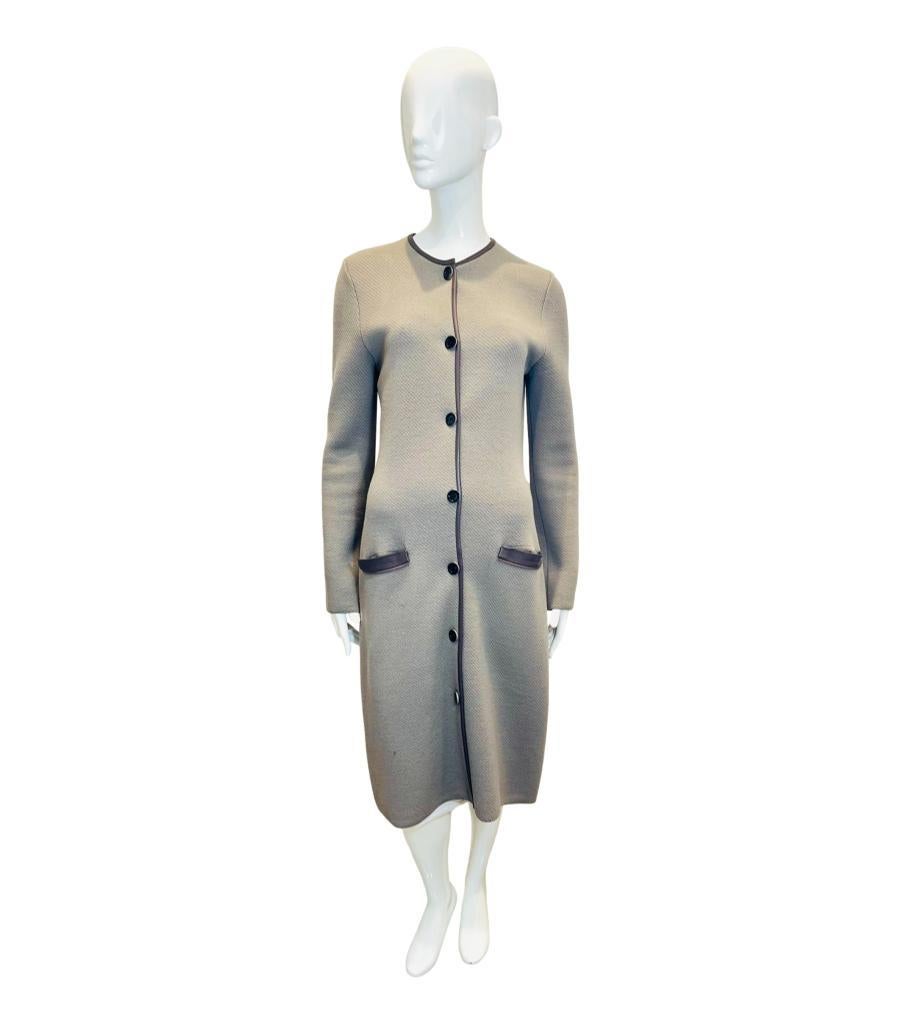 Christian Dior Wool Coat/Cardigan With Leather Trim

Greige coat designed with brown lambskin leather trims.

Featuring crew neckline and 'Dior' engraved centre button closure.

Styled with fitted silhouette and mid-calf length.

Size –