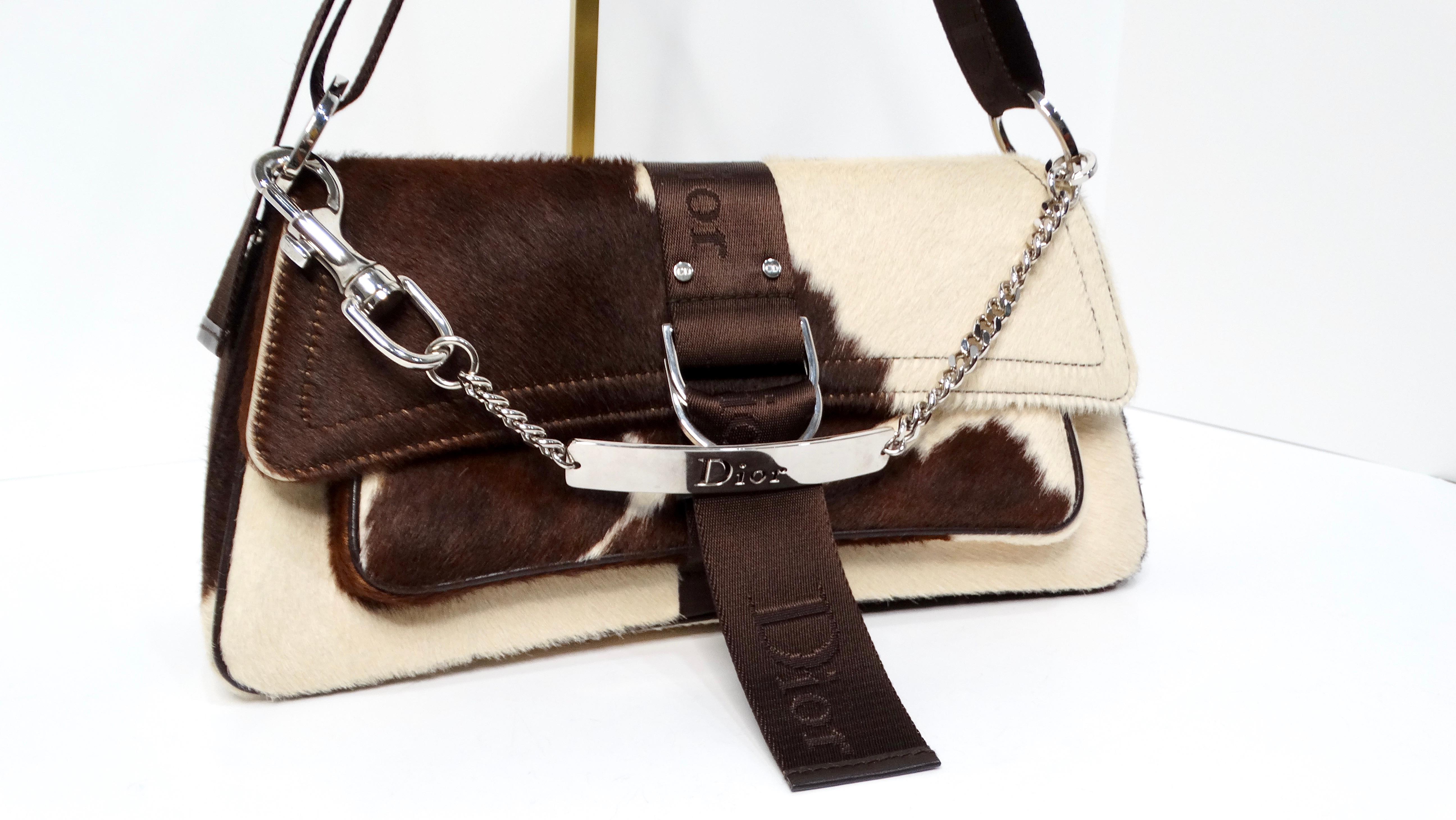 Introducing the Christian Dior Y2K Brown & Cream Pony Hair Shoulder Bag, a stunning accessory that embodies the essence of early 2000s fashion while remaining effortlessly chic. Circa 2004, during John Galliano's visionary era, this bag features a