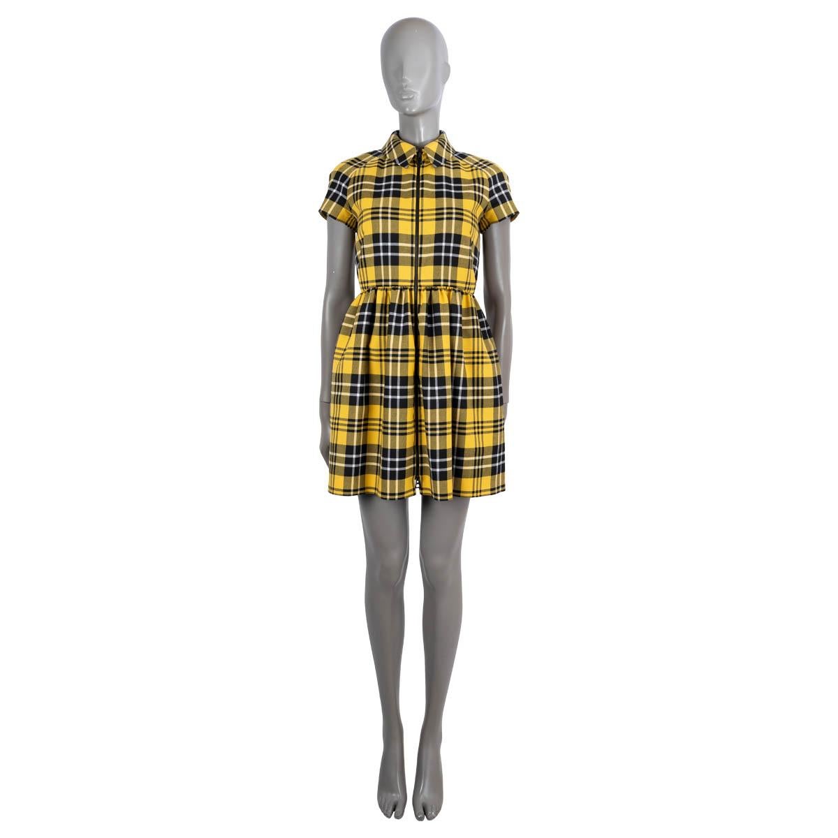 100% authentic Christian Dior Check'n'Dior mini dress in yellow and black plaid twill wool (100%). Features short raglan sleeves (sleeve measurement taken from the neck) and gathered skirt and two side pockets. Closes with a zipper on front. Lined