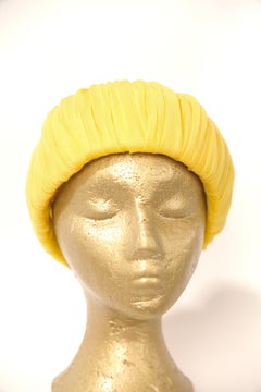 Christian Dior yellow pleated pillbox  style hat. C. 1960s