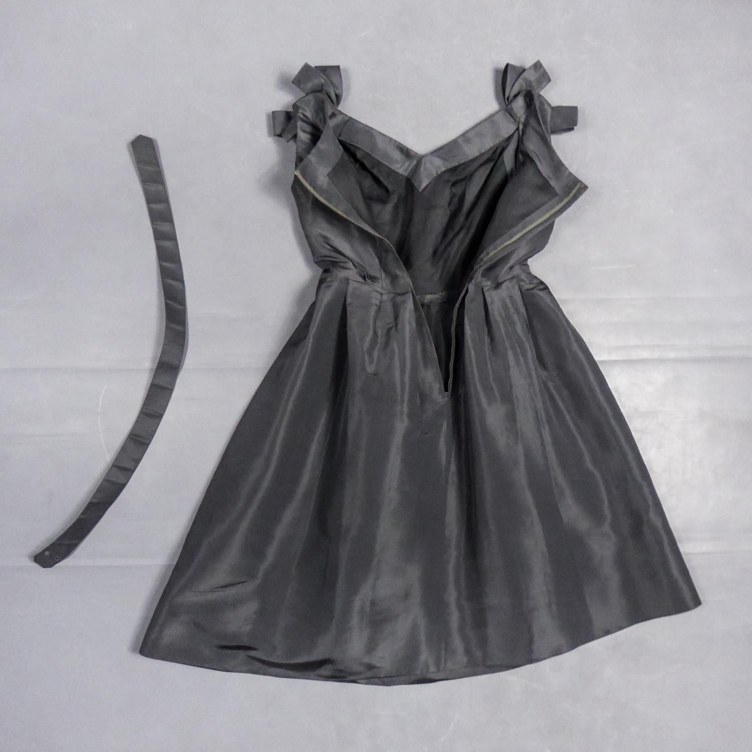 Circa 1958/1960

France

Beautiful anthracite gray silk faille cocktail dress from the period of Yves Mathieu Saint Laurent at the head of Maison Dior between 1958 and 1960. From the famous Trapèze line, this dress with fitted bust, V-neck and