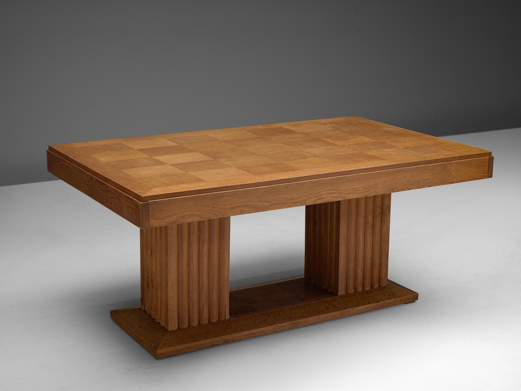Christian Krass, dining table, oak, France, 1930s.

This custom made large Art Deco table is made by Christian Krass. It has been executed with a very detailed wooden inlay on top. It shows great craftsmanship, as can be seen in the two solid bases,