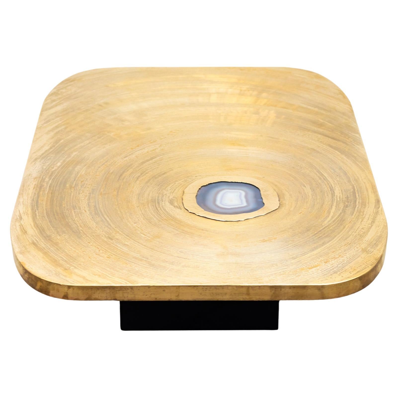 Impressive Coffee table from the 1980s signed by Christian Krekels.
Crafted from brass and features the incorporation of gemstone as decorative elements, here we have an beautiful agate. 
The brass top is beautifully engraved with a pattern that
