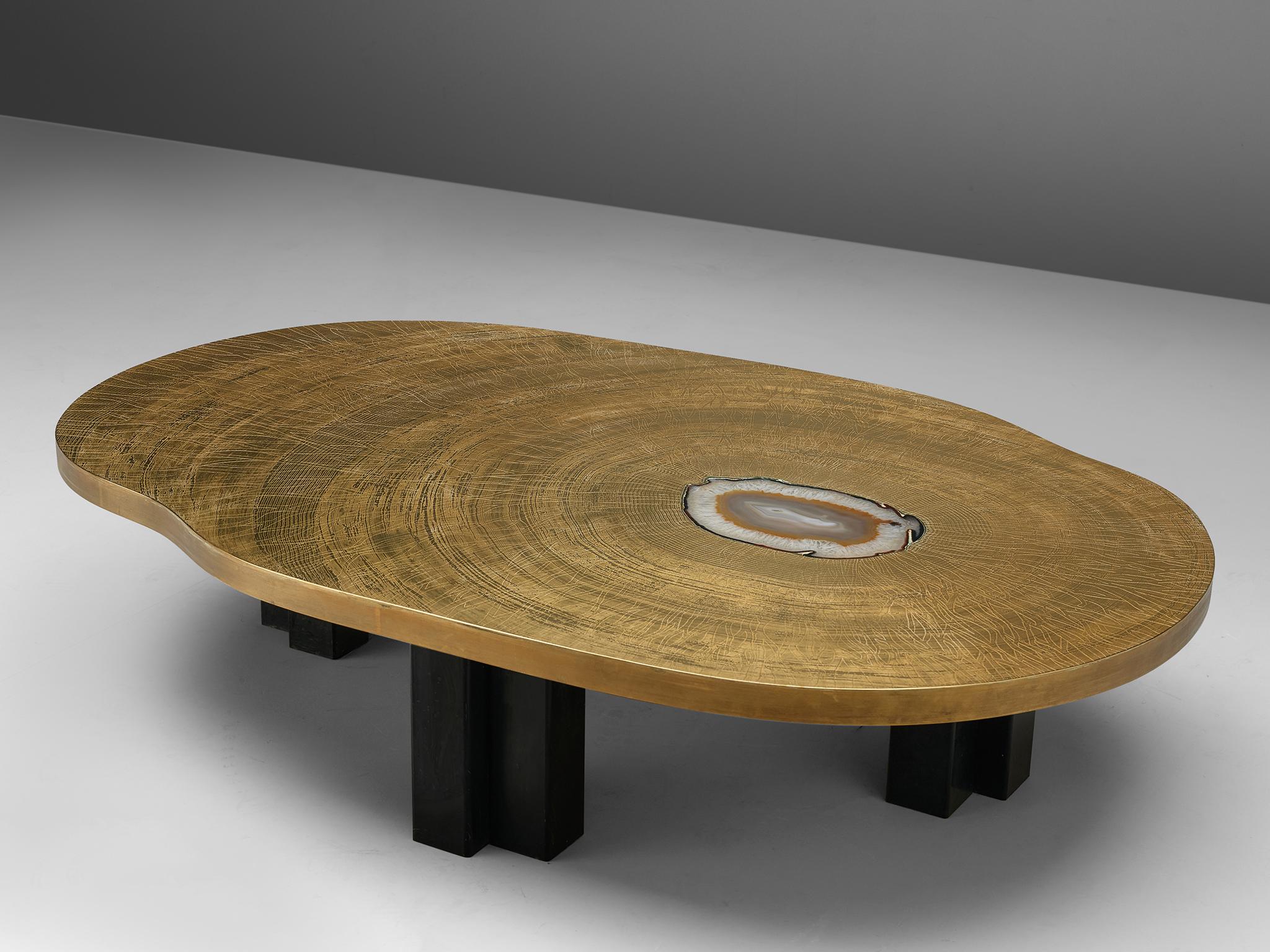 Christian Krekels, coffee table, brass and enameled steel, inlayed with agate, Belgium, circa 1980s.

This luxurious and refined coffee table features an etched brass tabletop and robust, dramatic black legs. The etched top shows two patterns that