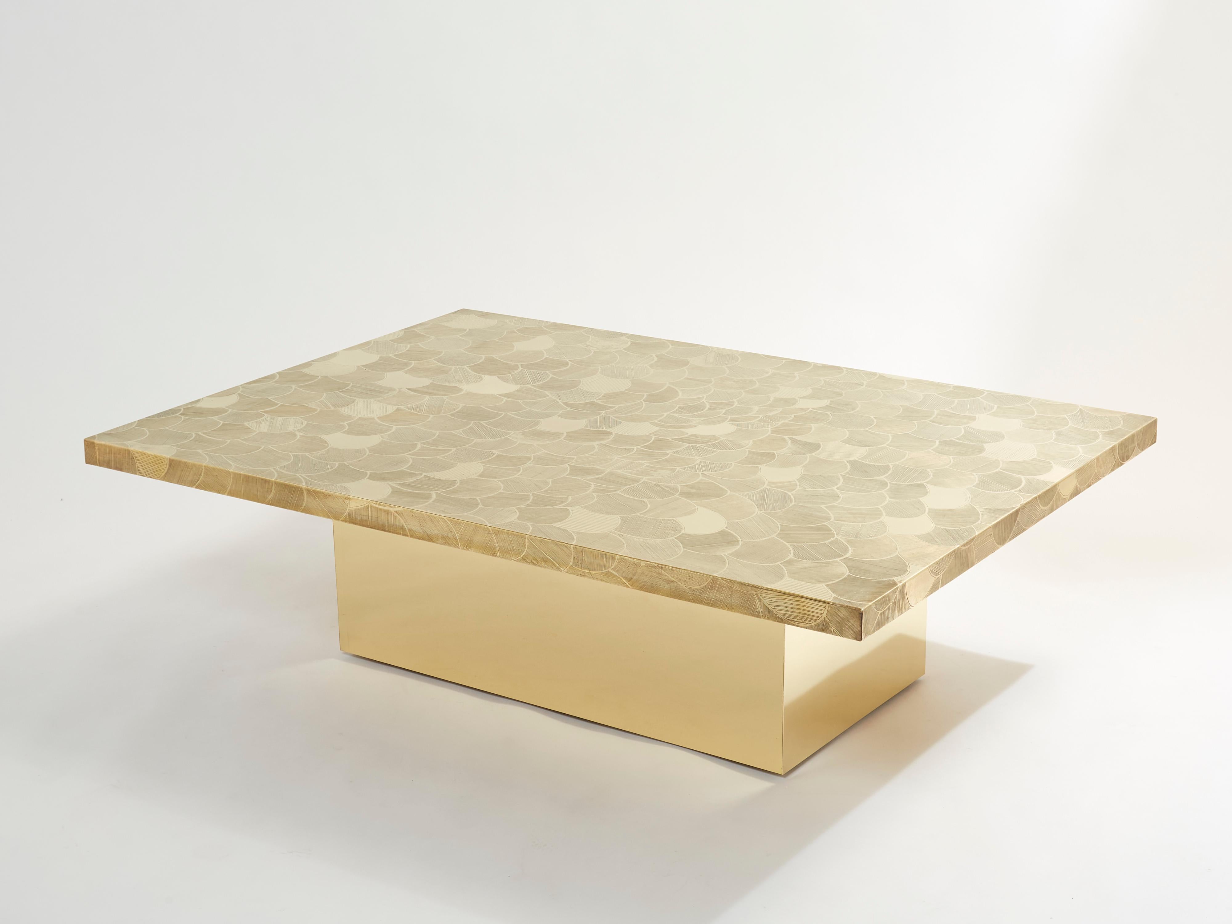 This is a beautiful Belgium coffee table signed by Christian Krekels in the late 1970s. The table features a beautiful decorative etched brass table top, and is set on a large wood base covered with brass. The rectangular top with vividly detailed