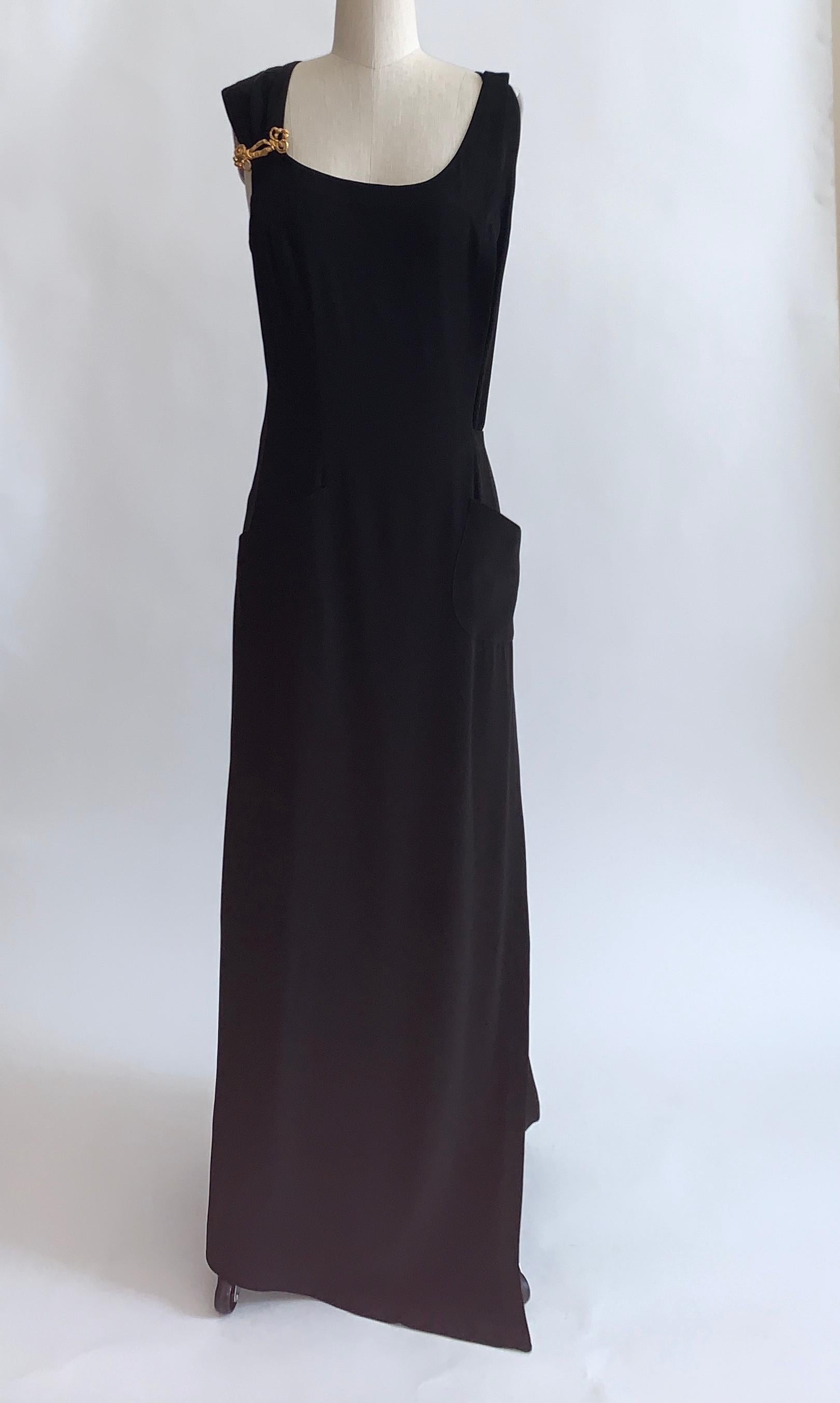 Christian Lacroix vintage black full length wrap dress with gold embellishment at one strap. Fastens closed at other strap and wraps with belt and snap at waist.  Patch pockets at front sides. 

Content unknown. 

Made in France.

Size not labeled,