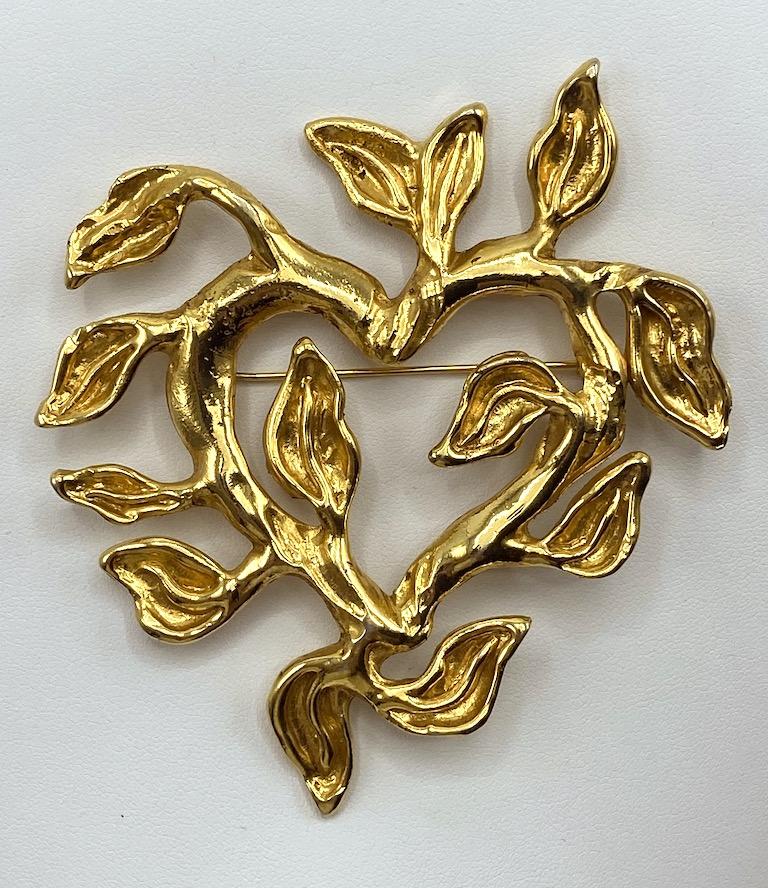An extremely large and sculptural brooch from the 1990s by famed fashion designer Christian Lacroix. It is one of his favorite themes of a heart made. The heart is sculpted of vines with leaves coming off in various sizes and directions. The brooch