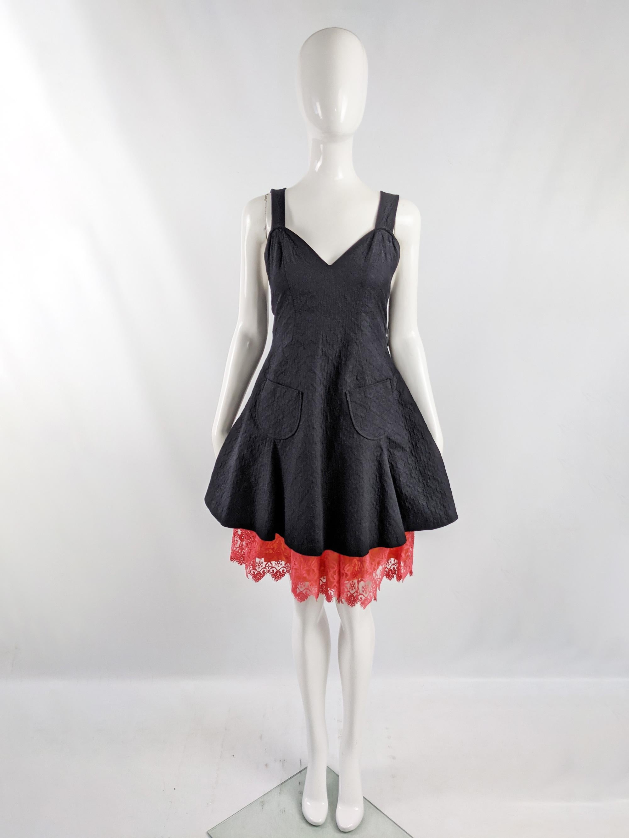 An unusual vintage womens Christian Lacroix party dress from the late 90s. In a black cotton jacquard fabric with an apron style wrap fastening at the back over the top of a coral pink and orange lace skirt. 

Size: Marked vintage 40 but measures