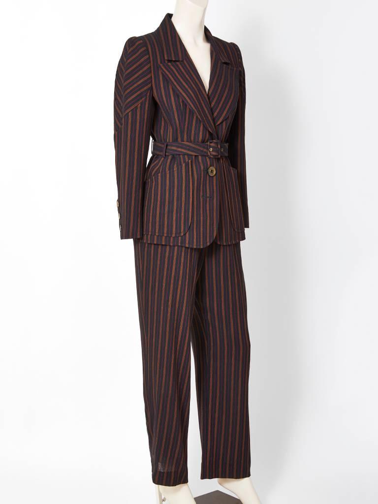 Christian Lacroix, belted, wool, stripe, pant suit, having wide notched lapels and deep pockets at the hips. Interesting shoulder treatment having the stripes placed making a chevron pattern. Pants are straight legged.
Designer : 

Place of Origin :