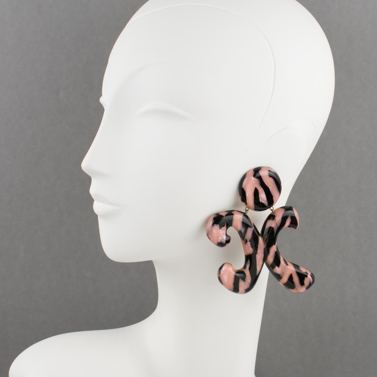 These rare, stunning Christian Lacroix Paris acrylic resin clip-on earrings feature an important stylized 