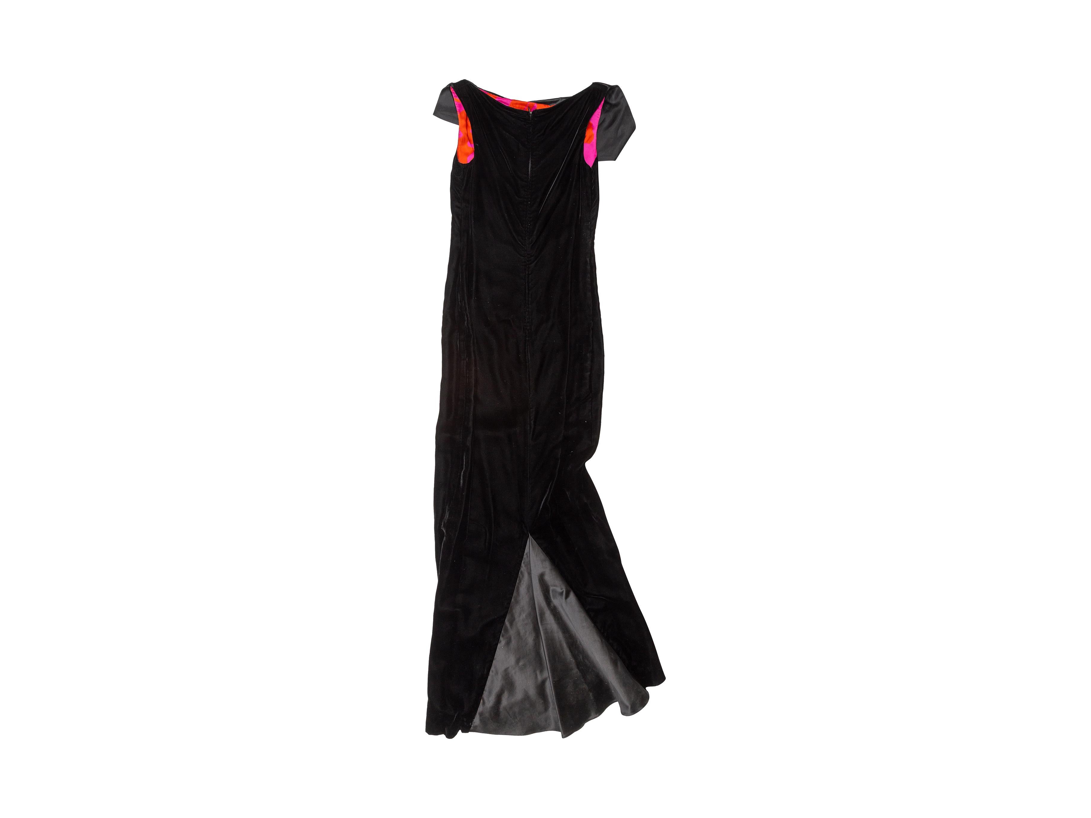 Product details: Black velvet off-the-shoulder evening gown by Christian Lacroix. Tonal satin trim. Vent at back hem. Zip closure at center back. 32
