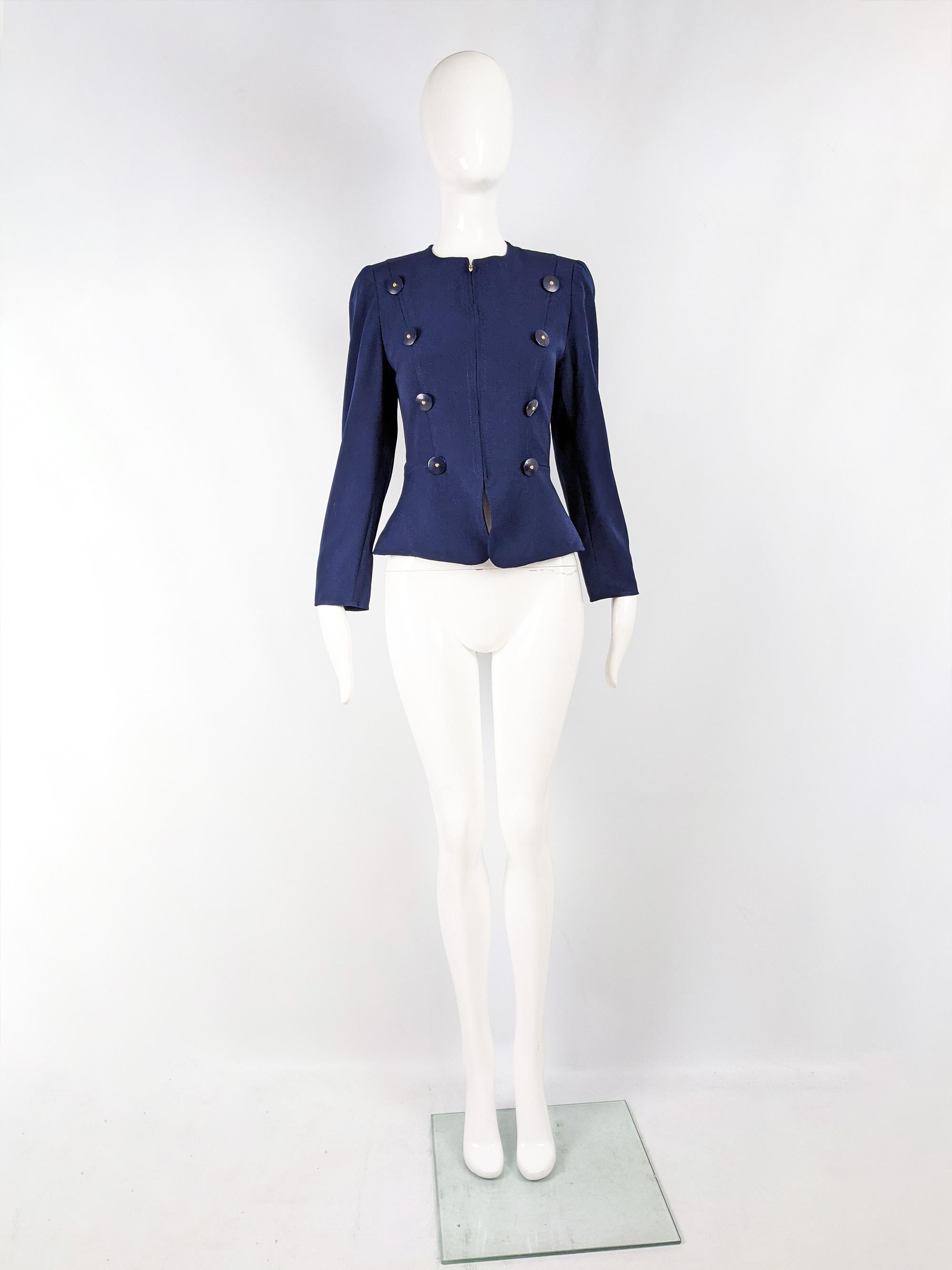 A chic vintage womens Christian Lacroix blazer from the 80s. In a blue wool with statement military style double breasted buttons, a collarless design and a fitted cut that flares out slightly at the hem, creating an hourglass silhouette. 

Size: