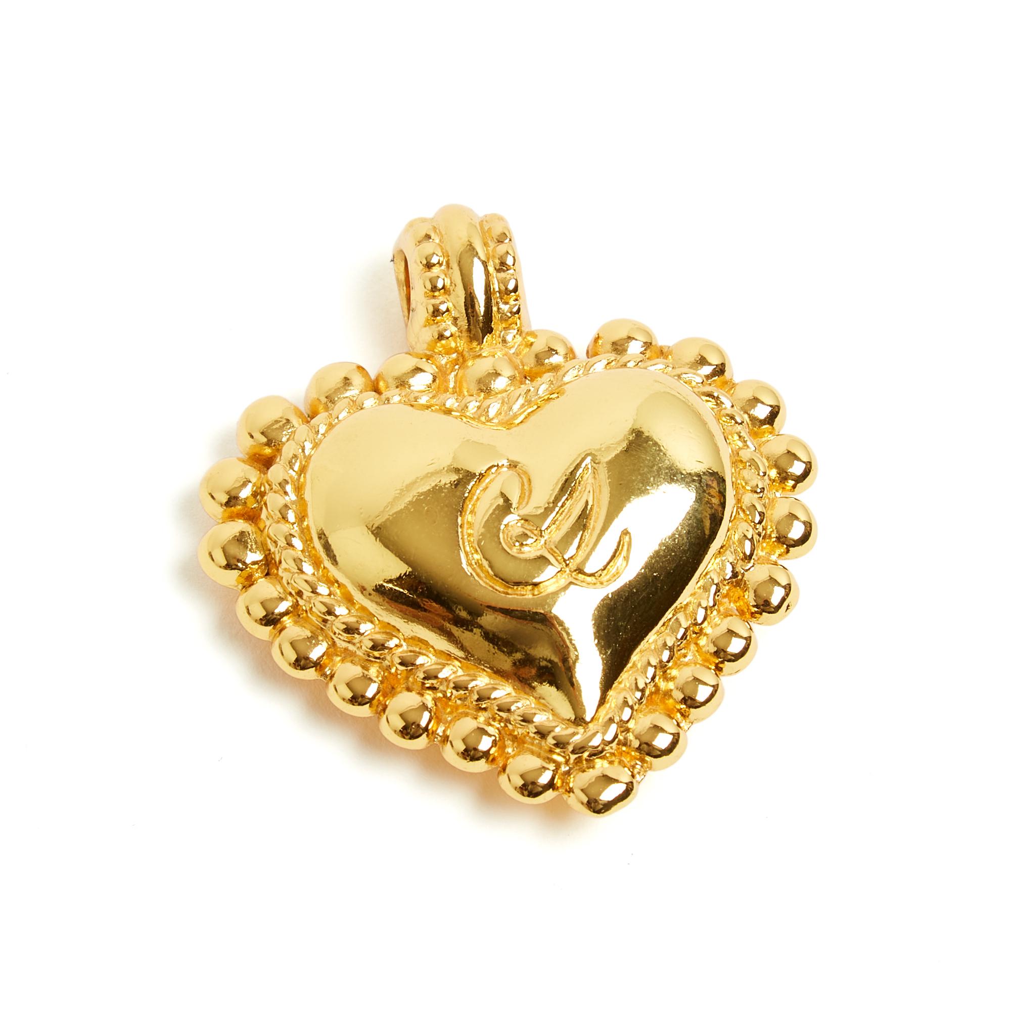 Christian Lacroix brooch and pendant in the shape of the designer's iconic heart in gold-plated metal, signed Lacroix and surrounded by a pearl motif, back signed and equipped with a pin for the brooch version and a bail for the pendant version.