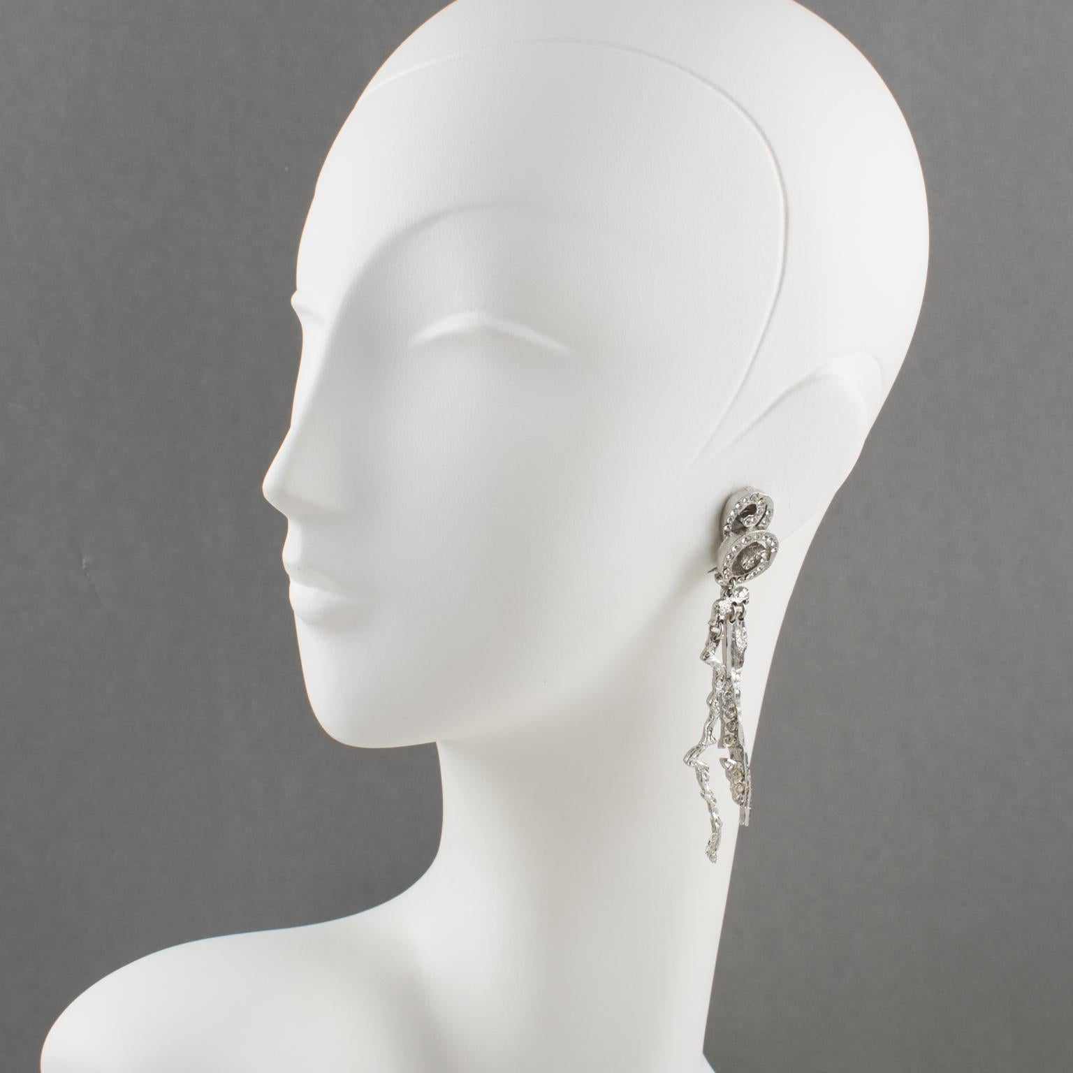 Superb Christian Lacroix Paris futurist clip-on earrings. Featuring a long dimensional brutalist dangling shape, with silvered metal all carved and see-thru, compliment with crystal rhinestones. Engraved 