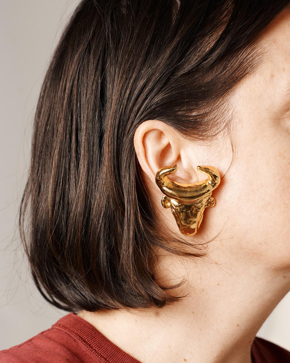 Late 80s - early 90s Christian Lacroix clip-on earrings in the shape of a bull's head. Made from gold-tone metal, the earrings are in very good condition. Signed on the reverse on the typical Lacroix plaque, 