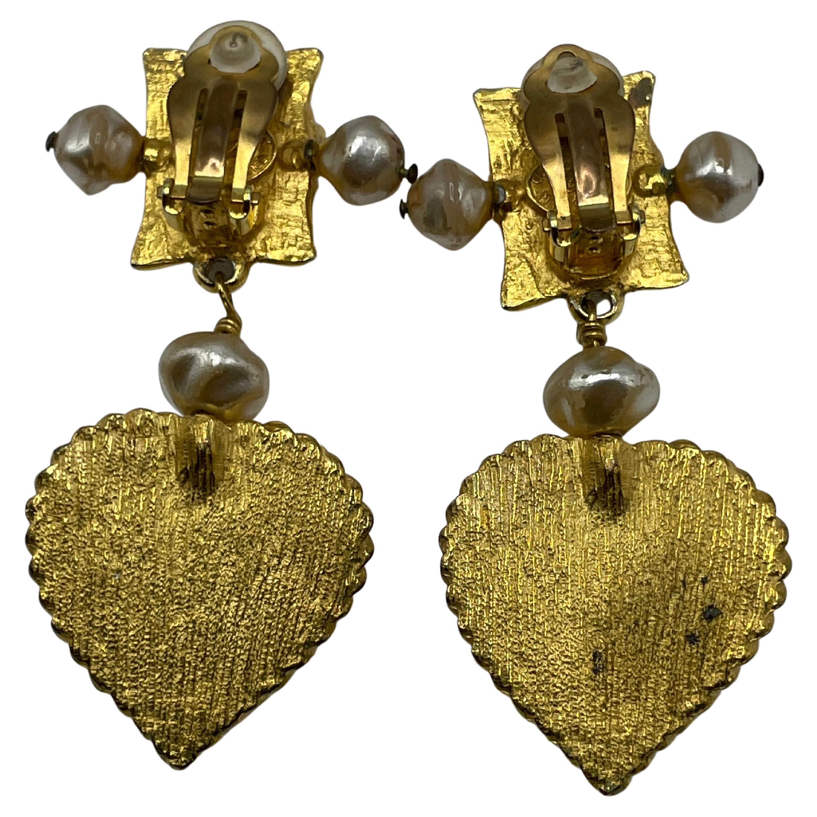 Pearl and velvet clip-on earrings by Christian Lacroix. The heart-shaped pattern on the earrings, which Christian Lacroix frequently employed to create his jewelry, is a representation of his creative aesthetic.
Stamp from Christian Lacroix on the