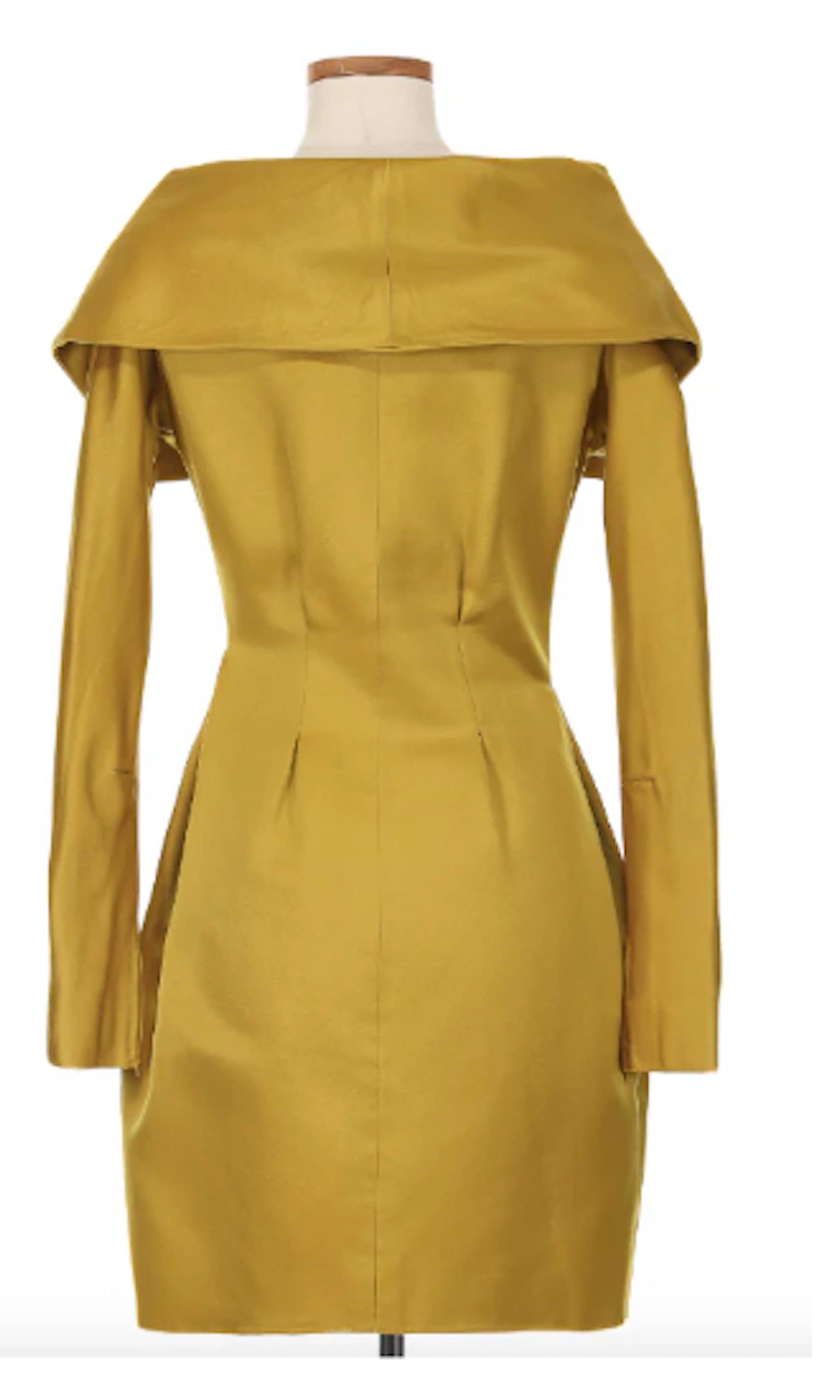 Christian Lacroix Couture Yellow Off the Shoulder Dress. This couture creation is crafted from a luxurious yellow silk that radiates vibrancy and elegance. From the waistline, the dress flares out gently, allowing for ease of movement, while