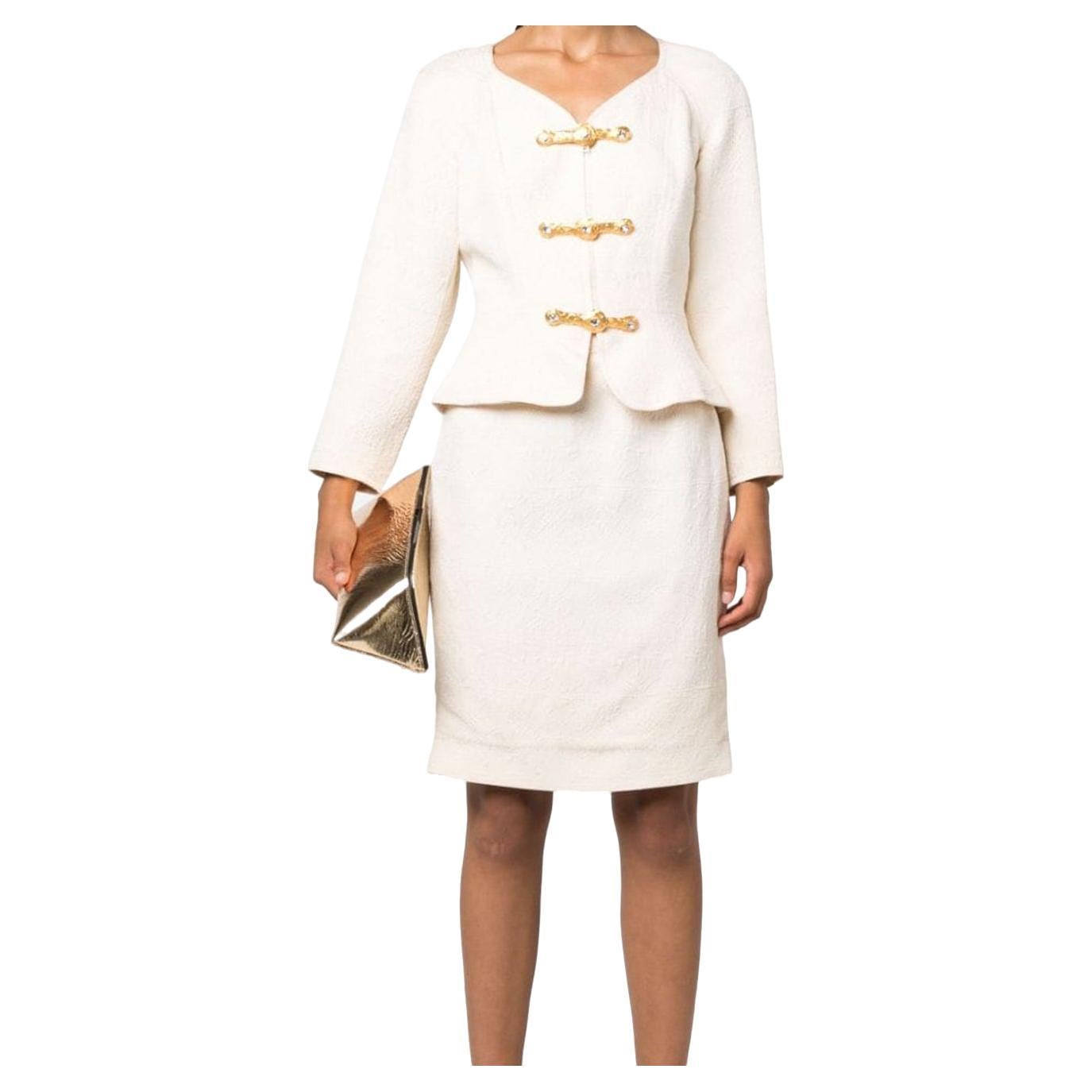 Christian Lacroix cream white toggle-fastening jacquard skirt suit featuring a wool-silk blend, a full jacquard.
Jacket gets a V-neck, a front jewel toggle fastening, crop sleeves, a peplum hem, a silk lining.
Skirt gets high waist, a concealed side
