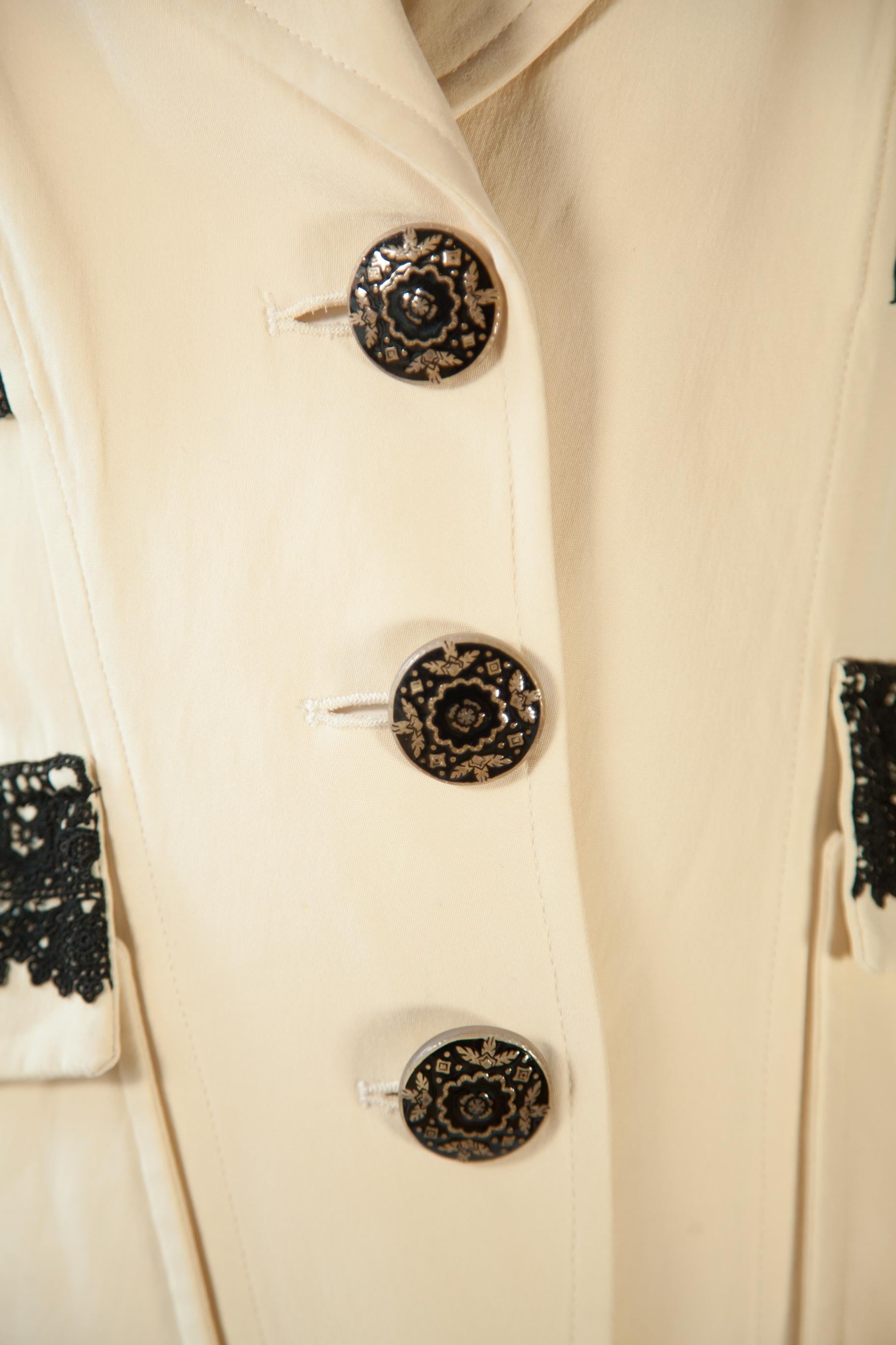 The Christian Lacroix creme blazer is an exquisite piece of fashion featuring three buttons and black lace detail along the pockets and cuffs. Crafted with luxury materials, this chic blazer will make you stand out in any crowd.

Christian Lacroix