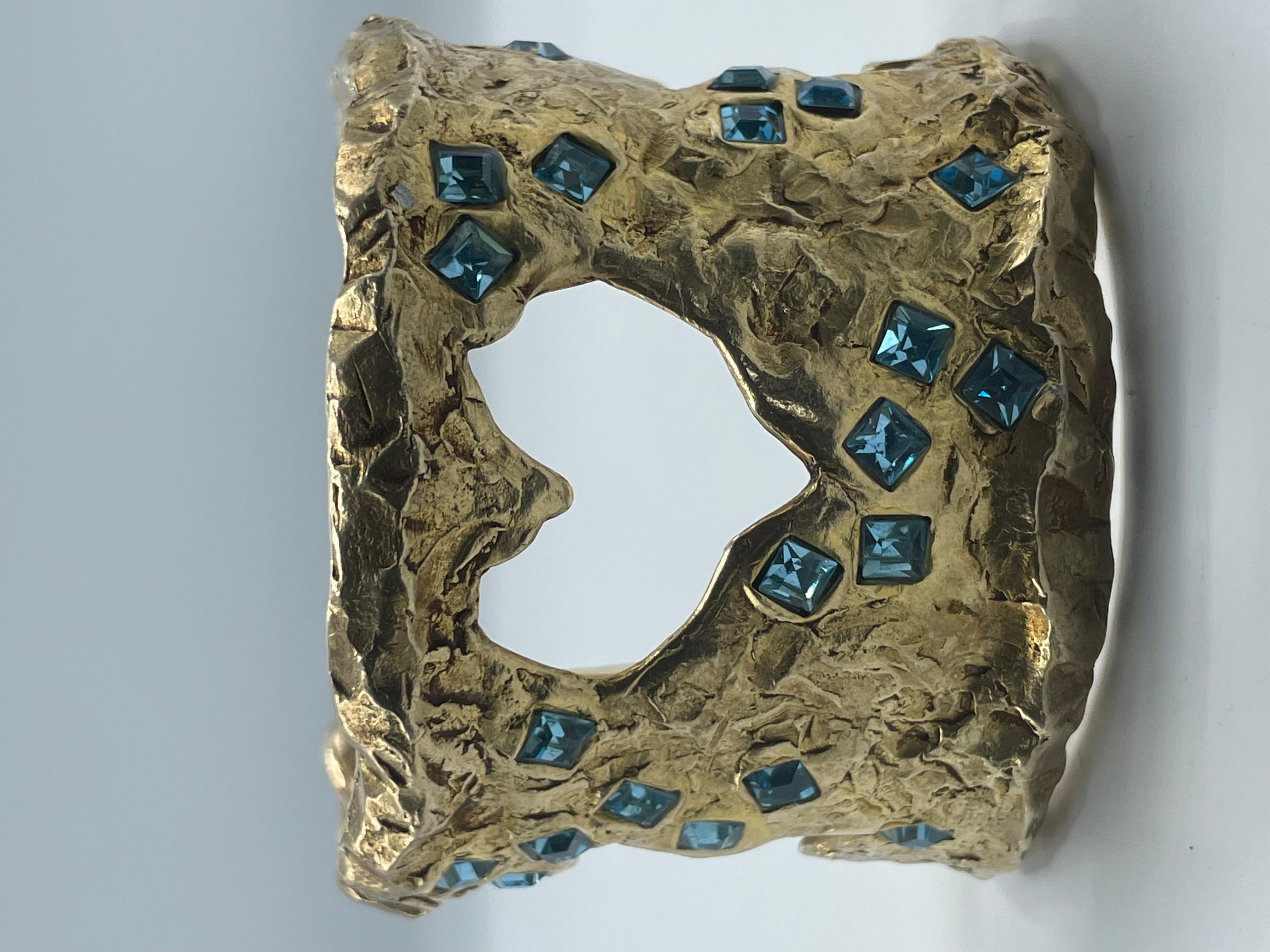 Beautifull Cuff in gold plate with blue strass with an openwork in the shape of heart, cross and star. Signed inside Christian Lacroix Made in France. 