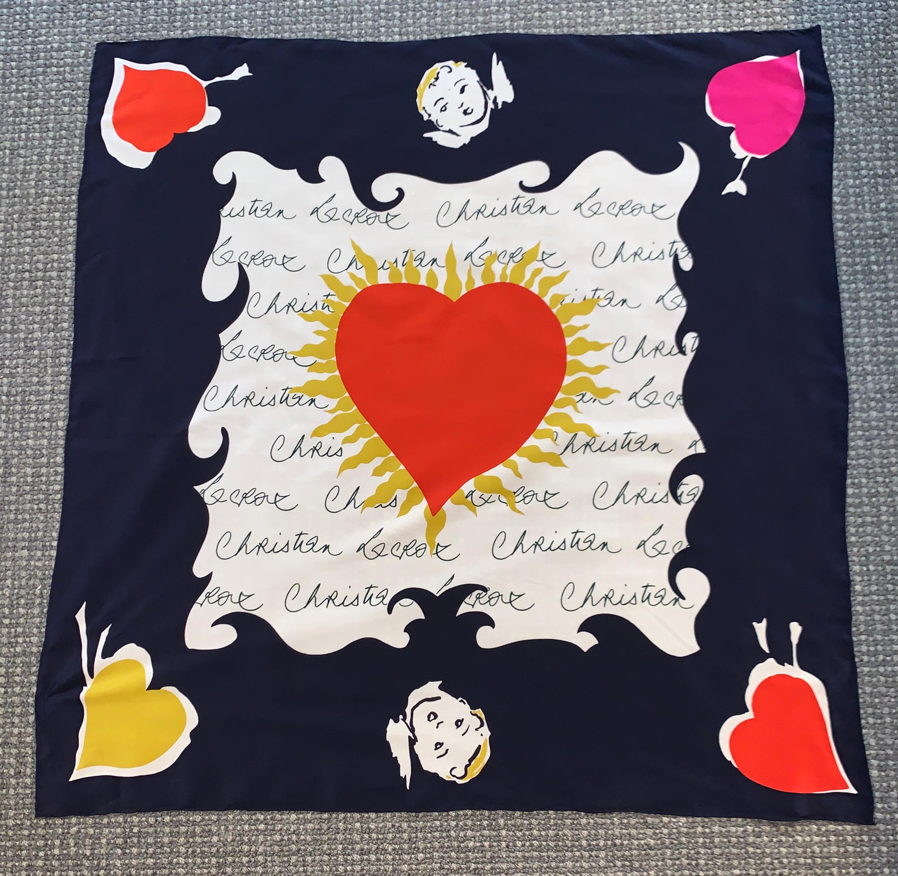 Christian Lacroix silk scarf with black and white signature print featuring cupids and hearts in red, yellow, and pink. Hand rolled edges.

100% silk.

Made in Italy.

Measures approximately 34